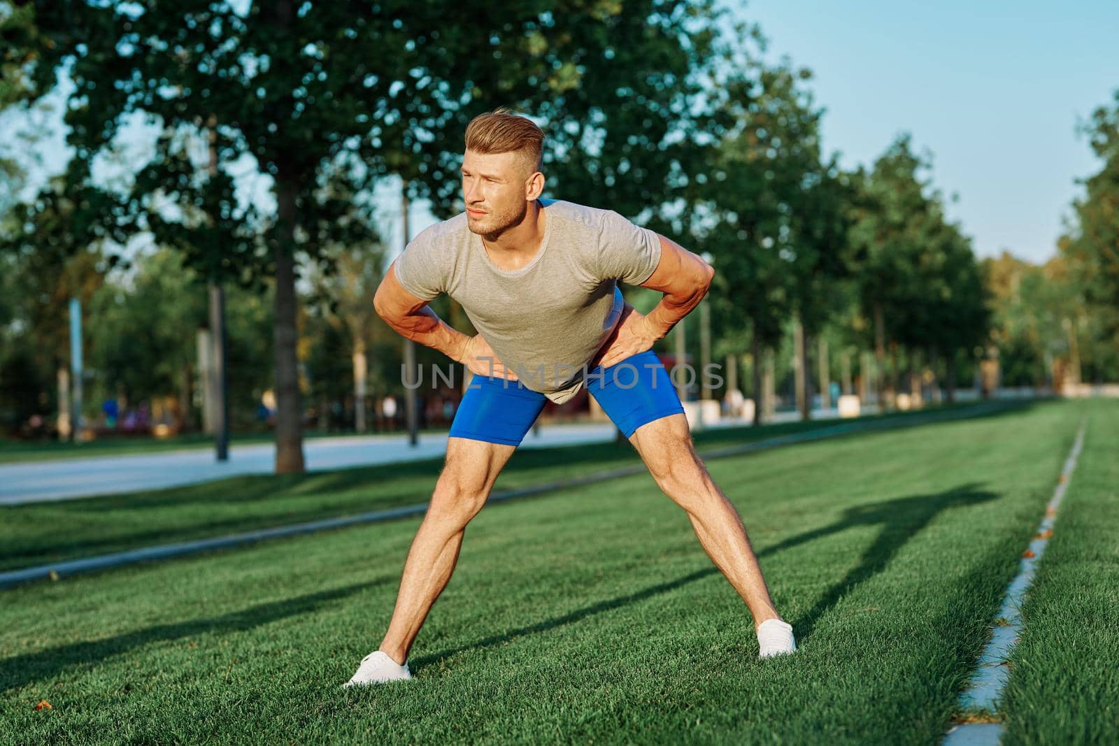 sporty man in the park on the lawn exercise lifestyle. High quality photo