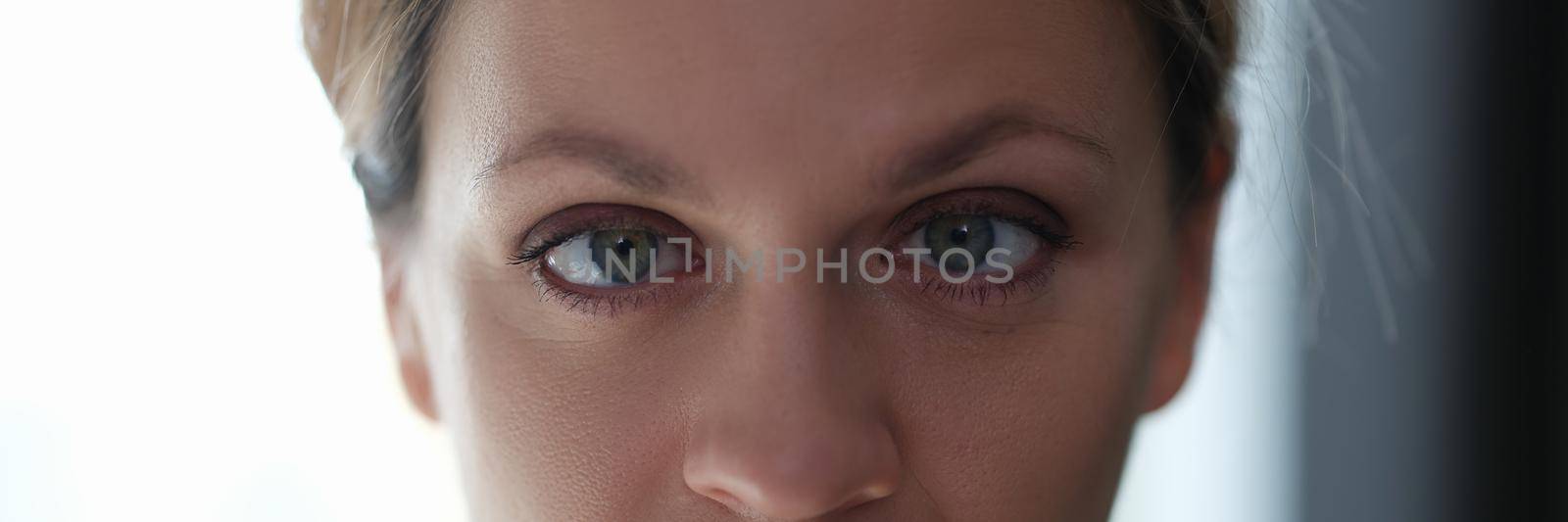 Portrait of young beautiful woman with squint eyes by kuprevich