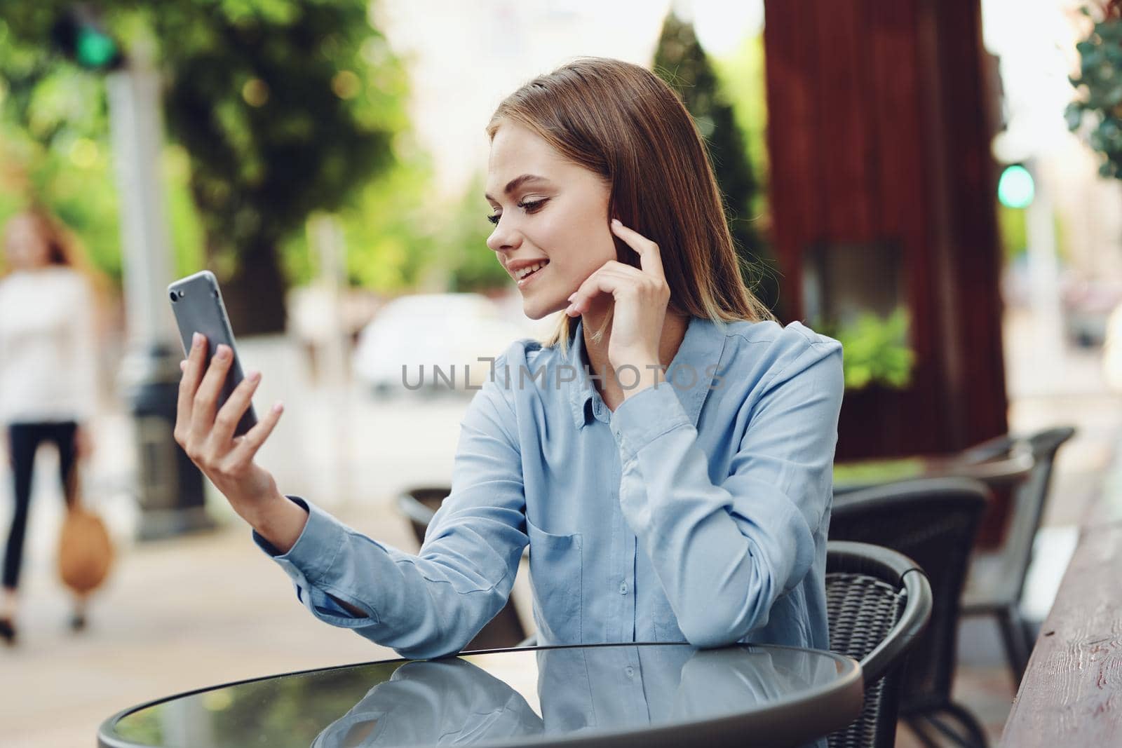 Business woman in a cafe in the summer outdoors on vacation. High quality photo