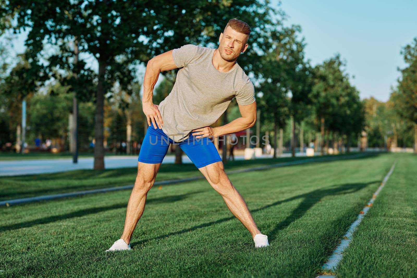 sporty man in the park on the lawn exercise lifestyle. High quality photo