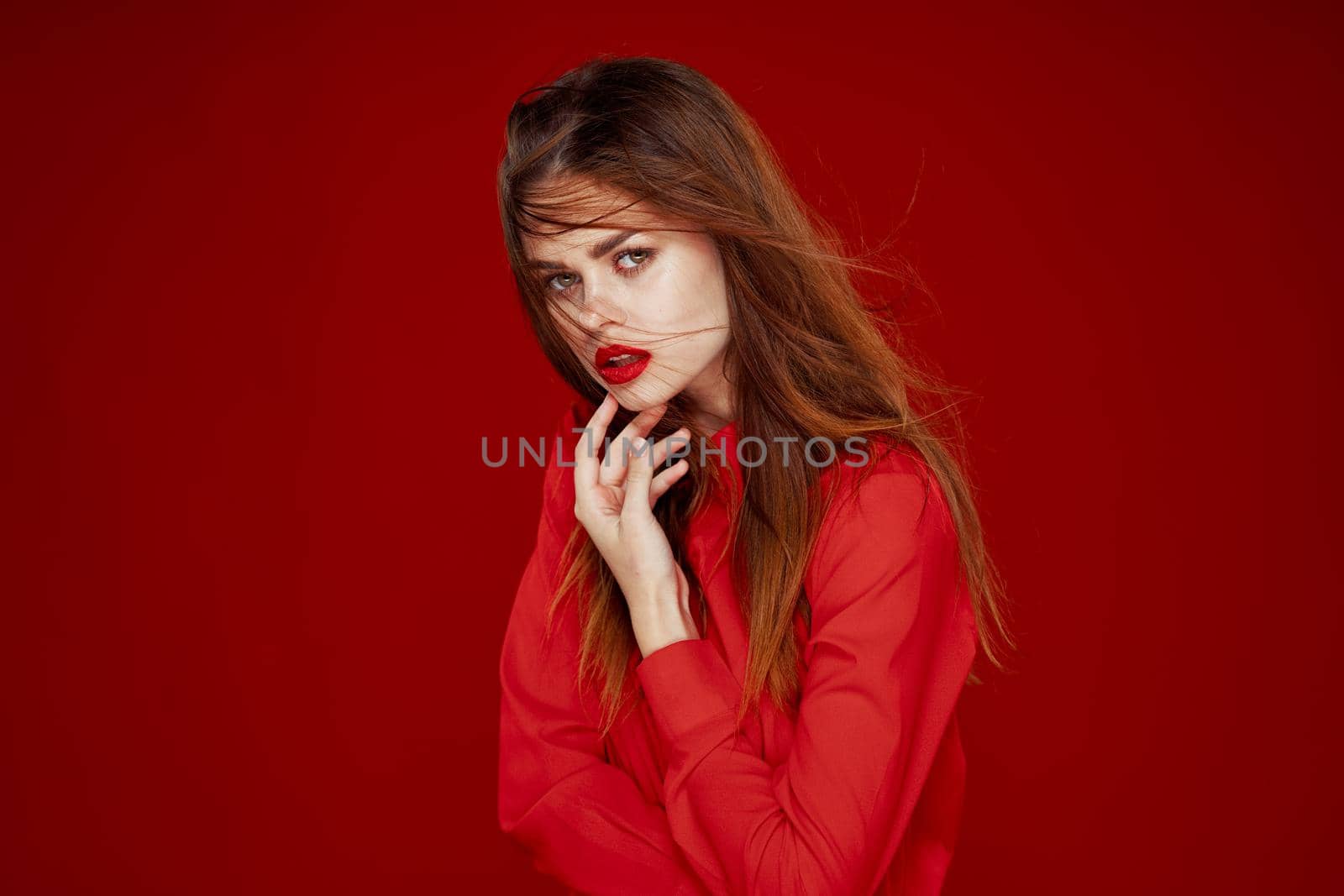 woman with red hair fashion posing red shirt glamor. High quality photo