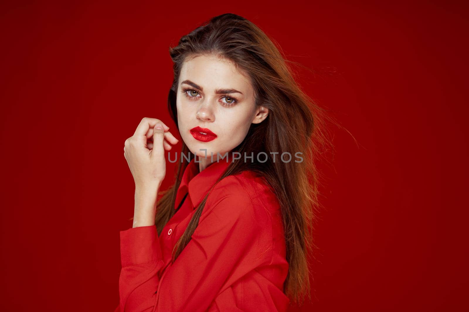 woman with red hair fashion posing red shirt glamor. High quality photo