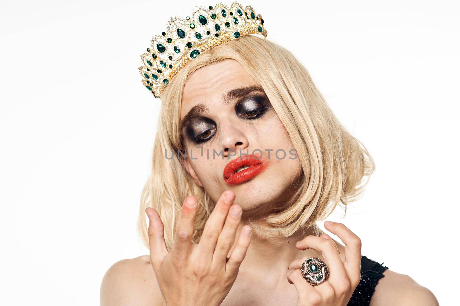 man in women's dress wig makeup posing bisexual. High quality photo
