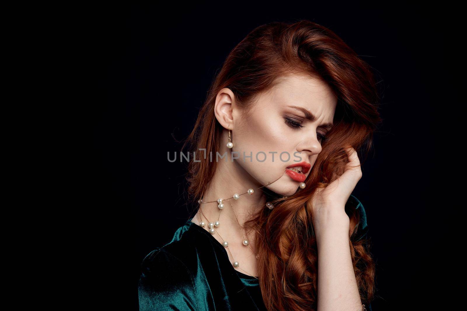 pretty woman decoration cosmetics posing Black background. High quality photo