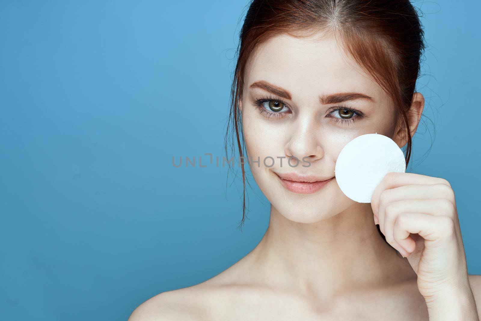 woman with bare shoulders cotton pads hygiene skin care. High quality photo