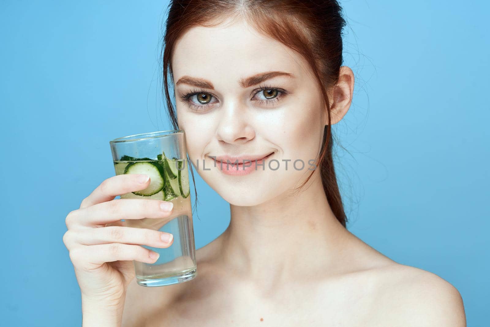 pretty woman with cucumber drink health vitamins. High quality photo