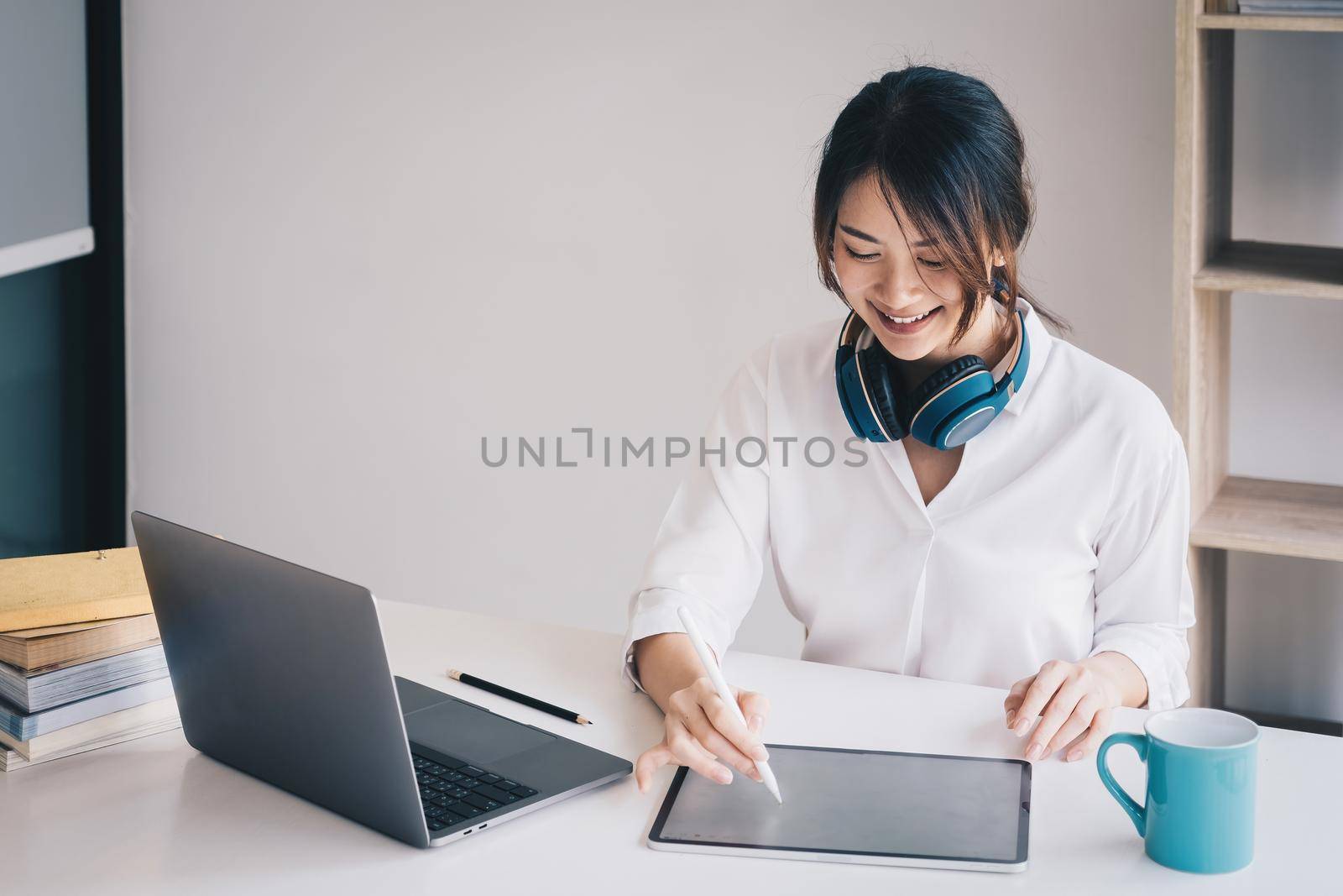 Casual business woman writing on tablet in home office. Business planning, tax, account, financial concept