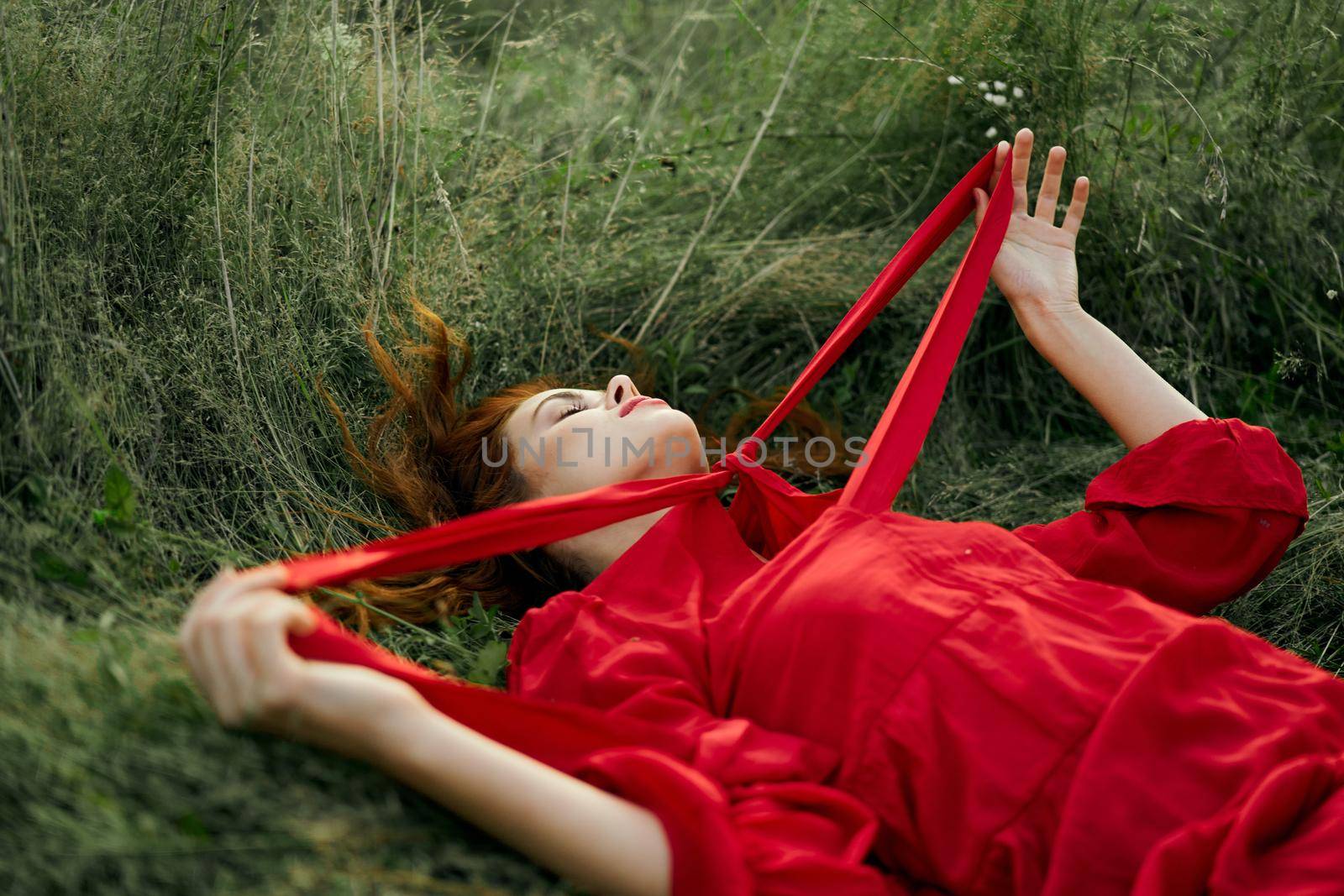 woman in red dress lying on the grass fresh air nature romance by Vichizh