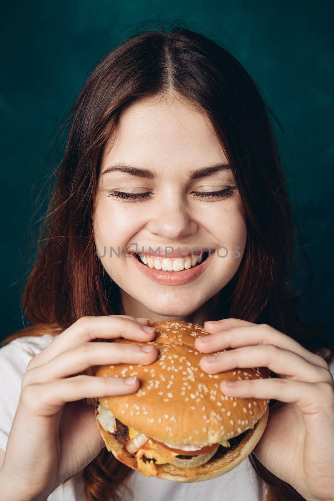 cheerful woman eating hamburger snack close-up lifestyle. High quality photo