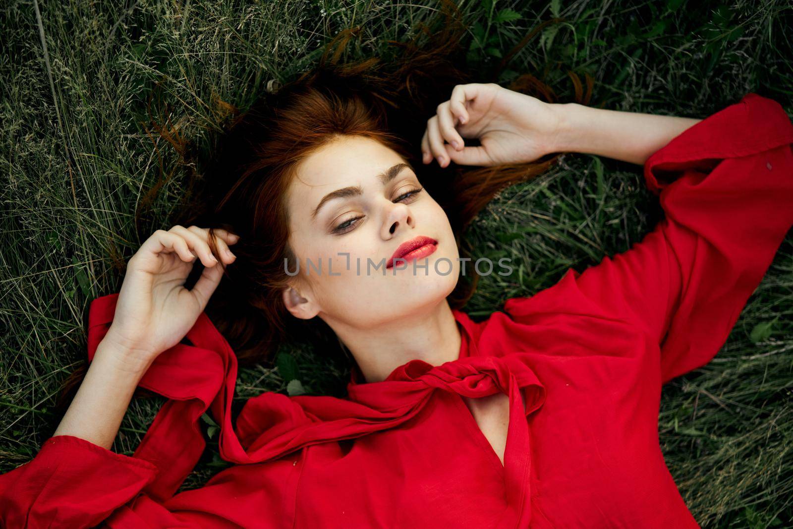 woman in red dress lies on the grass address fashion summer by Vichizh