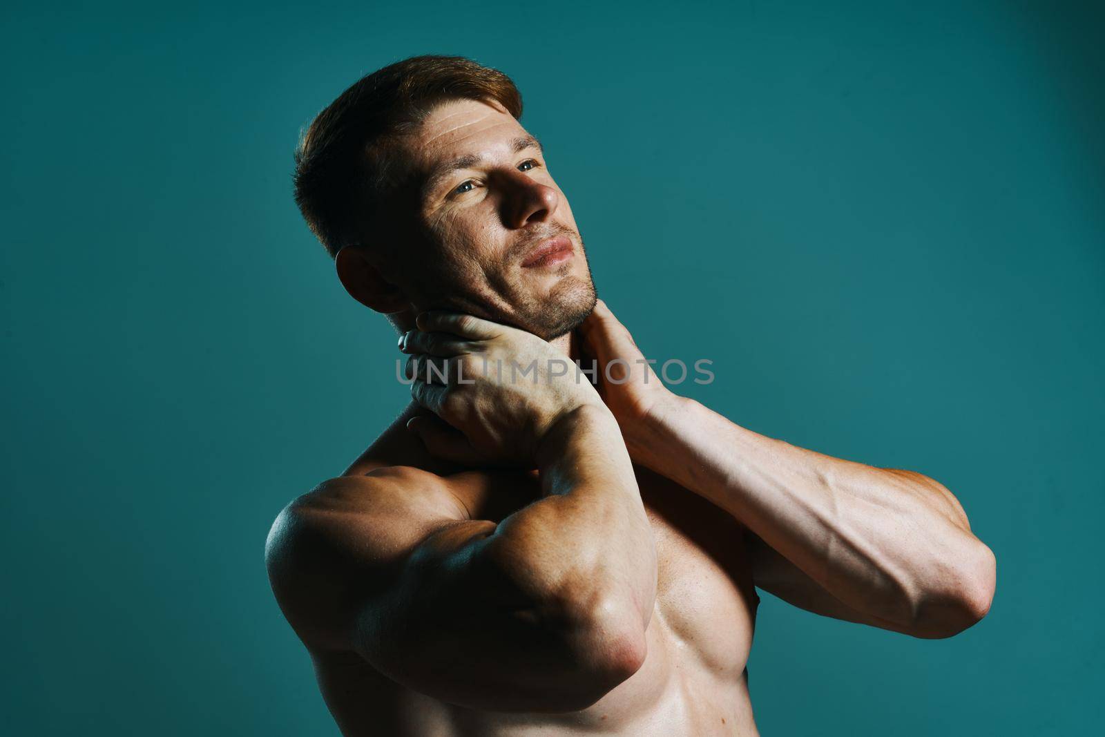 athletic man with pumped up muscular body workout green background. High quality photo