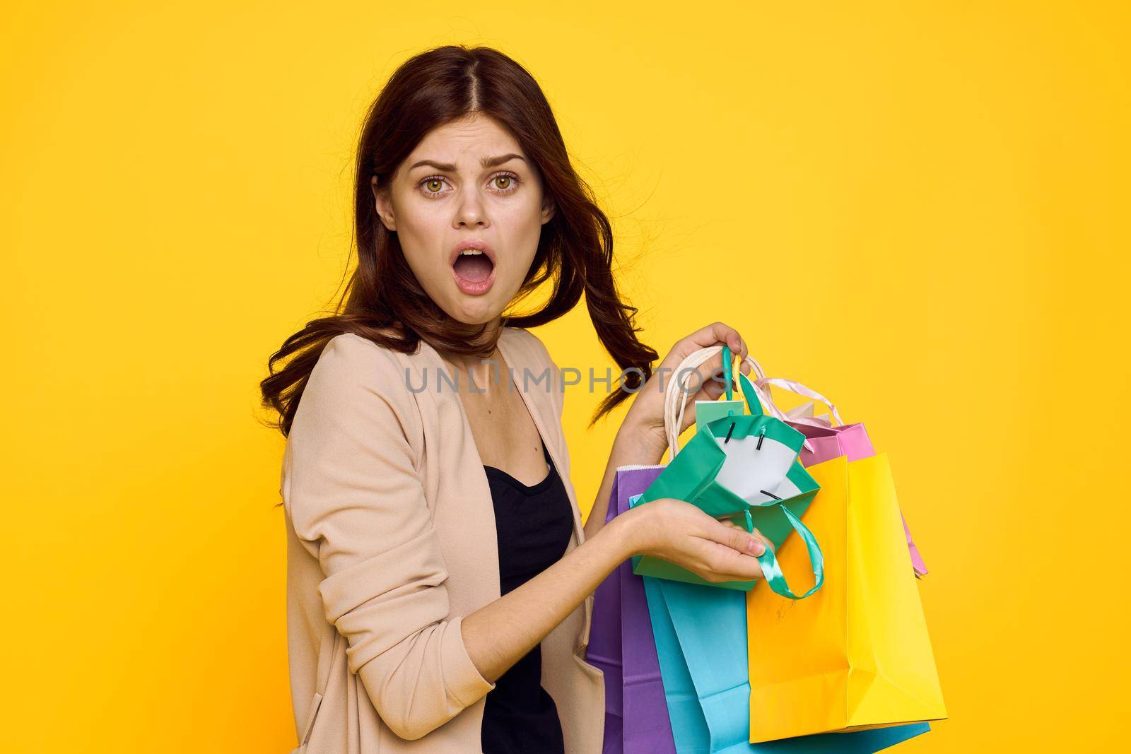 pretty woman multicolored packs emotions shopping fashion studio model. High quality photo