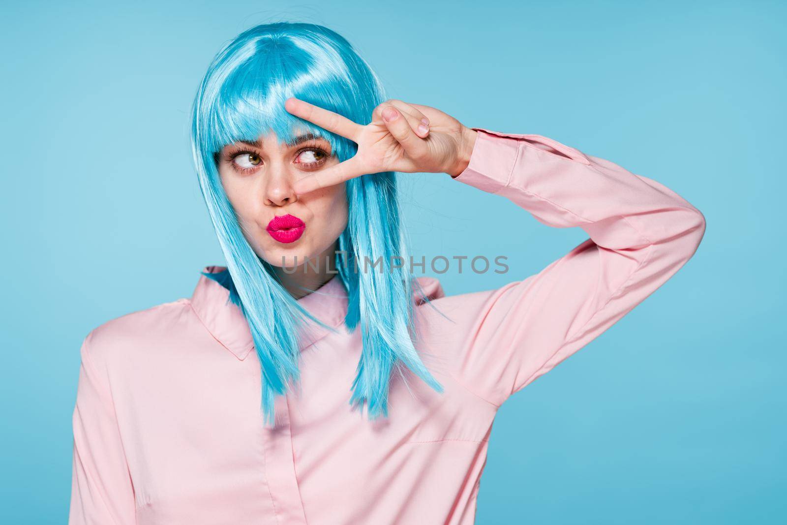 cheerful glamorous woman in pink shirt blue wig makeup model. High quality photo