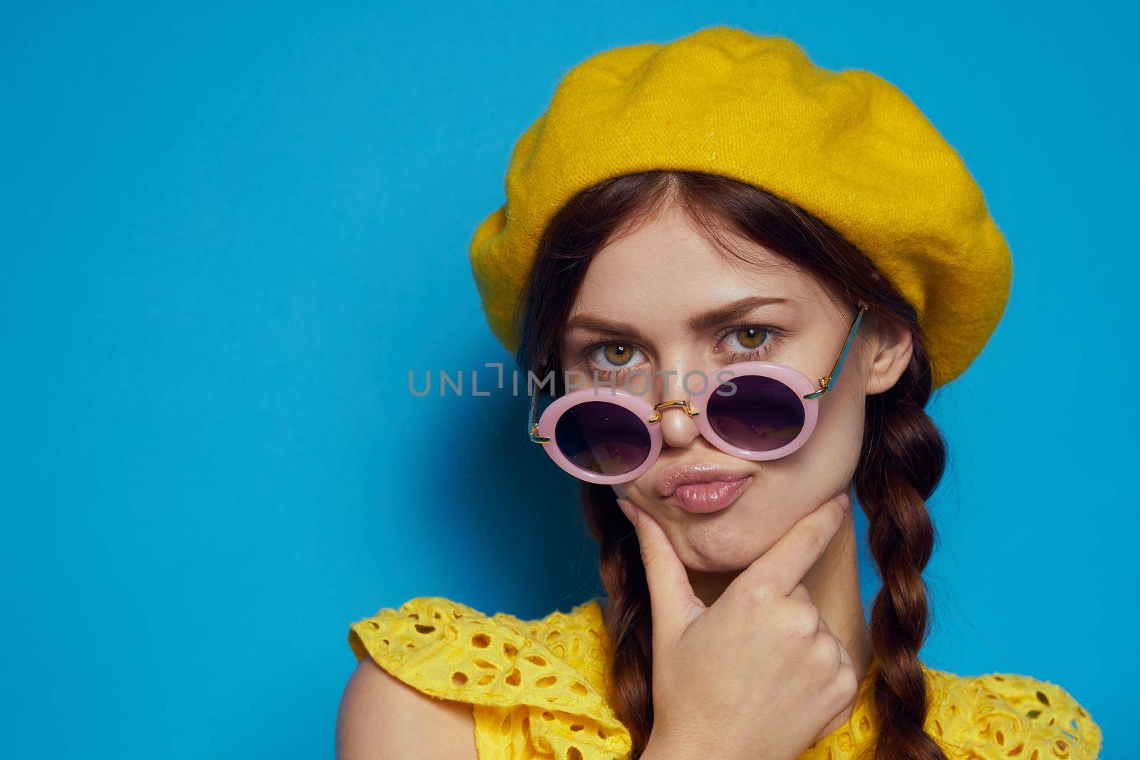 glamorous woman in a yellow hat Shopaholic fashion style blue background. High quality photo