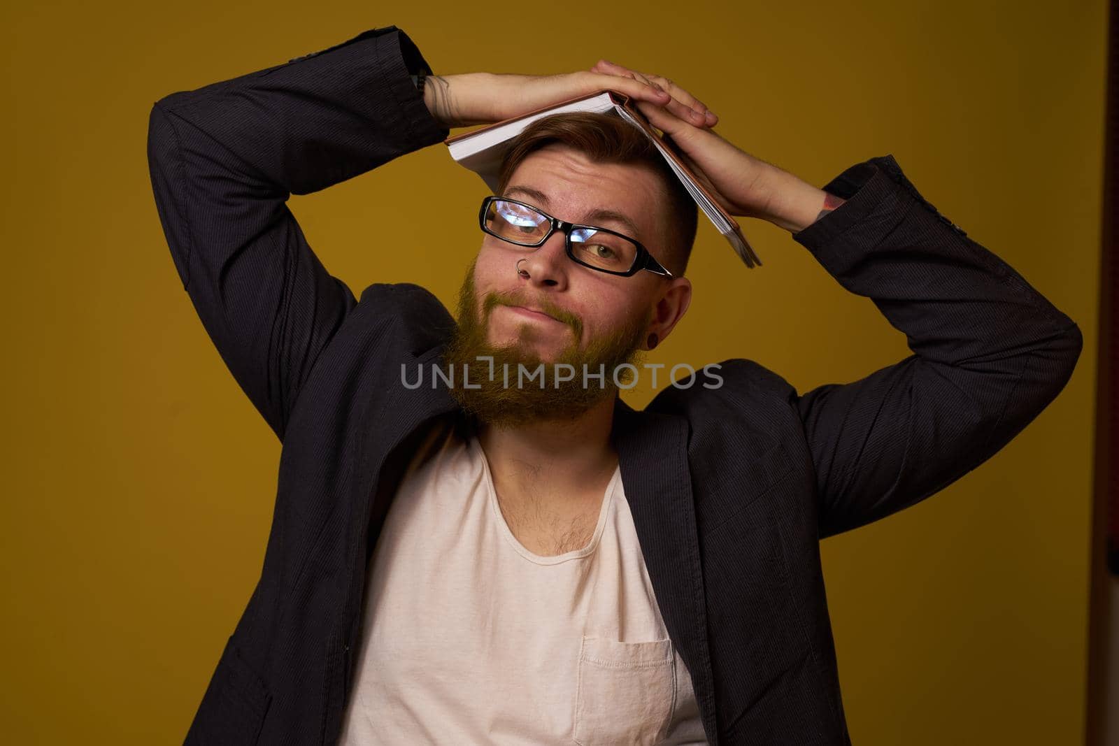 bearded man in a black jacket with a book in his hands education. High quality photo