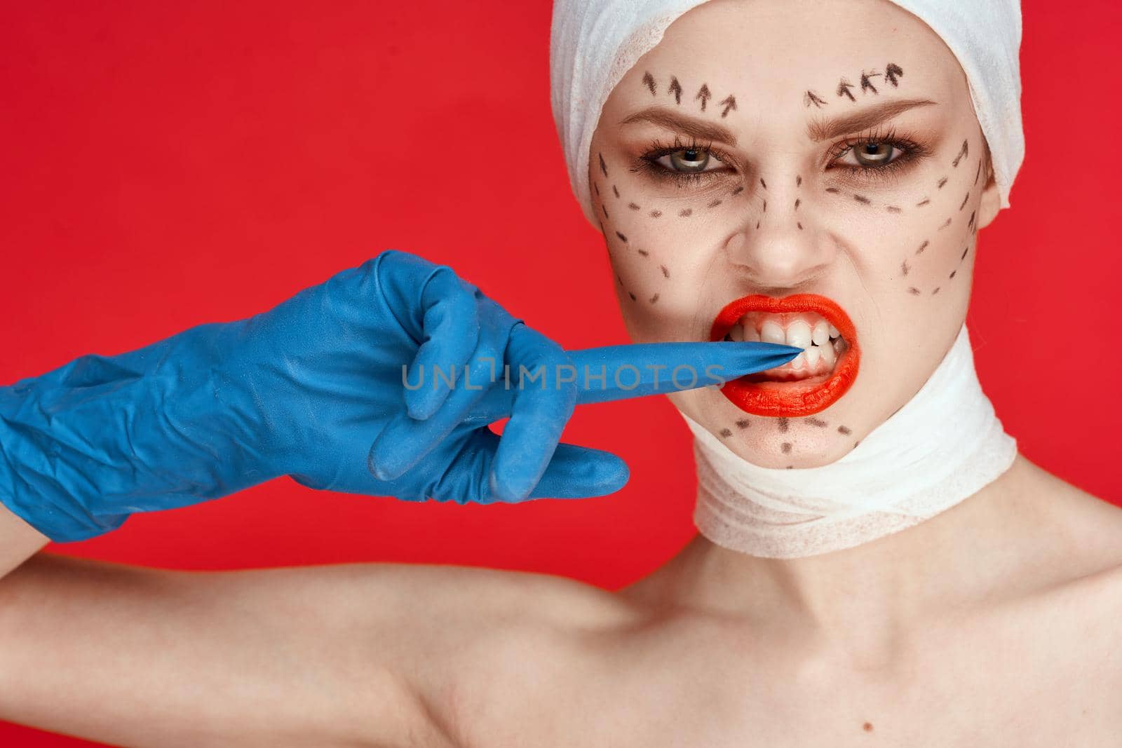 beautiful woman posing in blue gloves red lips surgery facial rejuvenation studio lifestyle. High quality photo