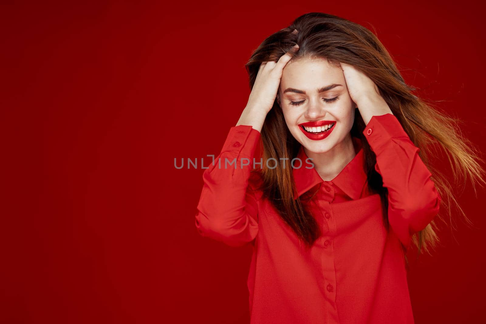 woman with red hair fashion posing red shirt glamor. High quality photo