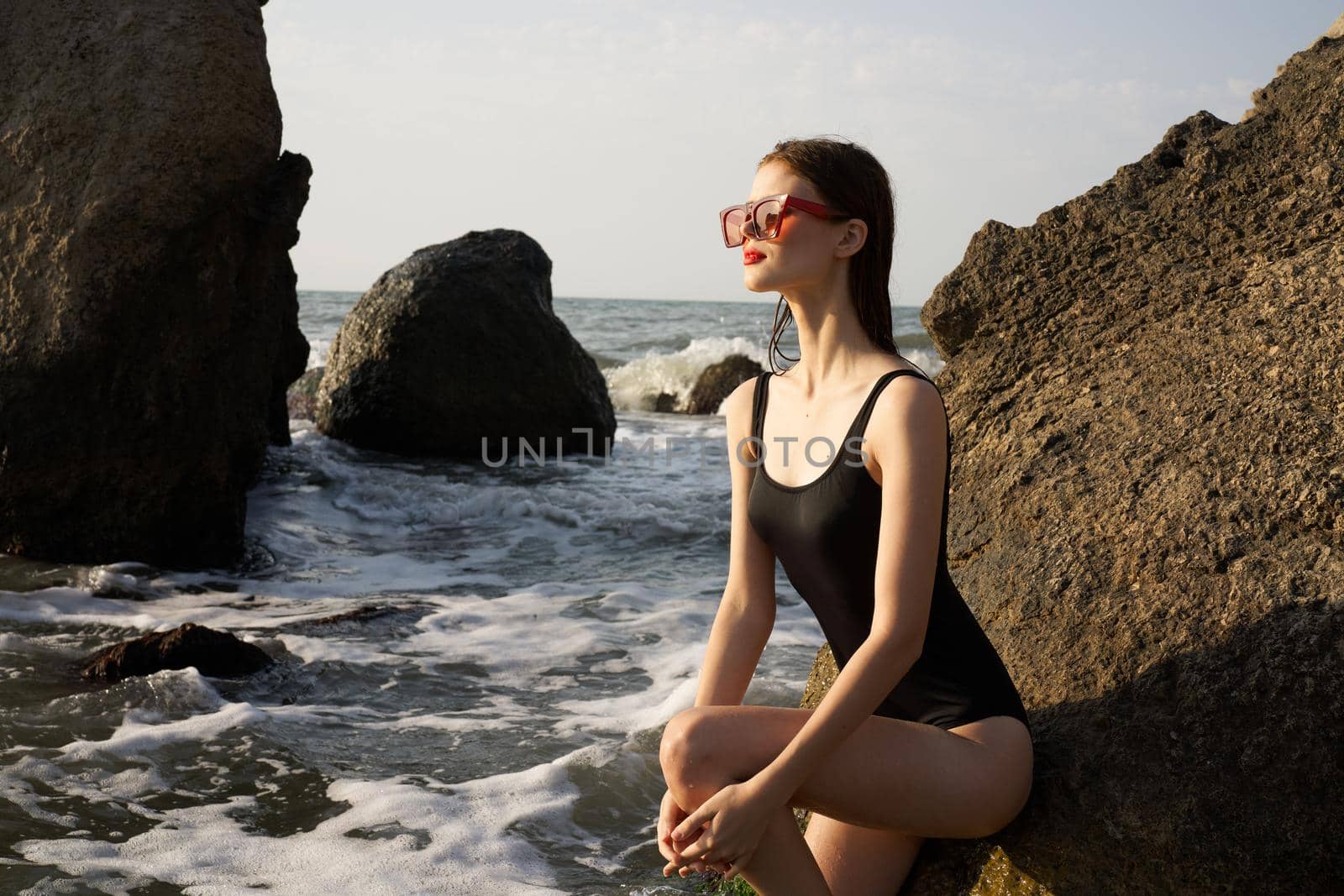 pretty woman in swimsuit island rocks posing summer. High quality photo