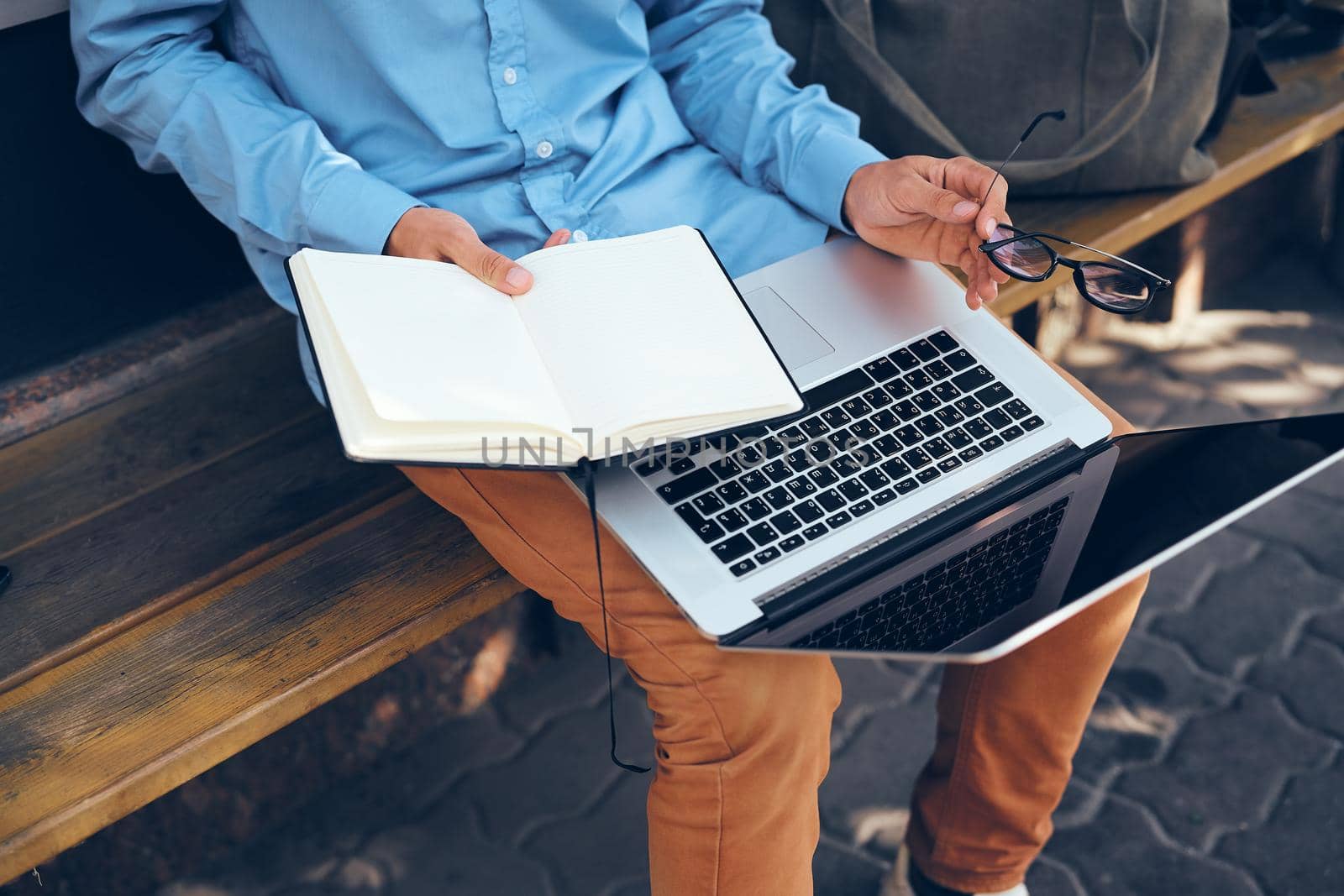 man with laptop outdoors in the park. High quality photo