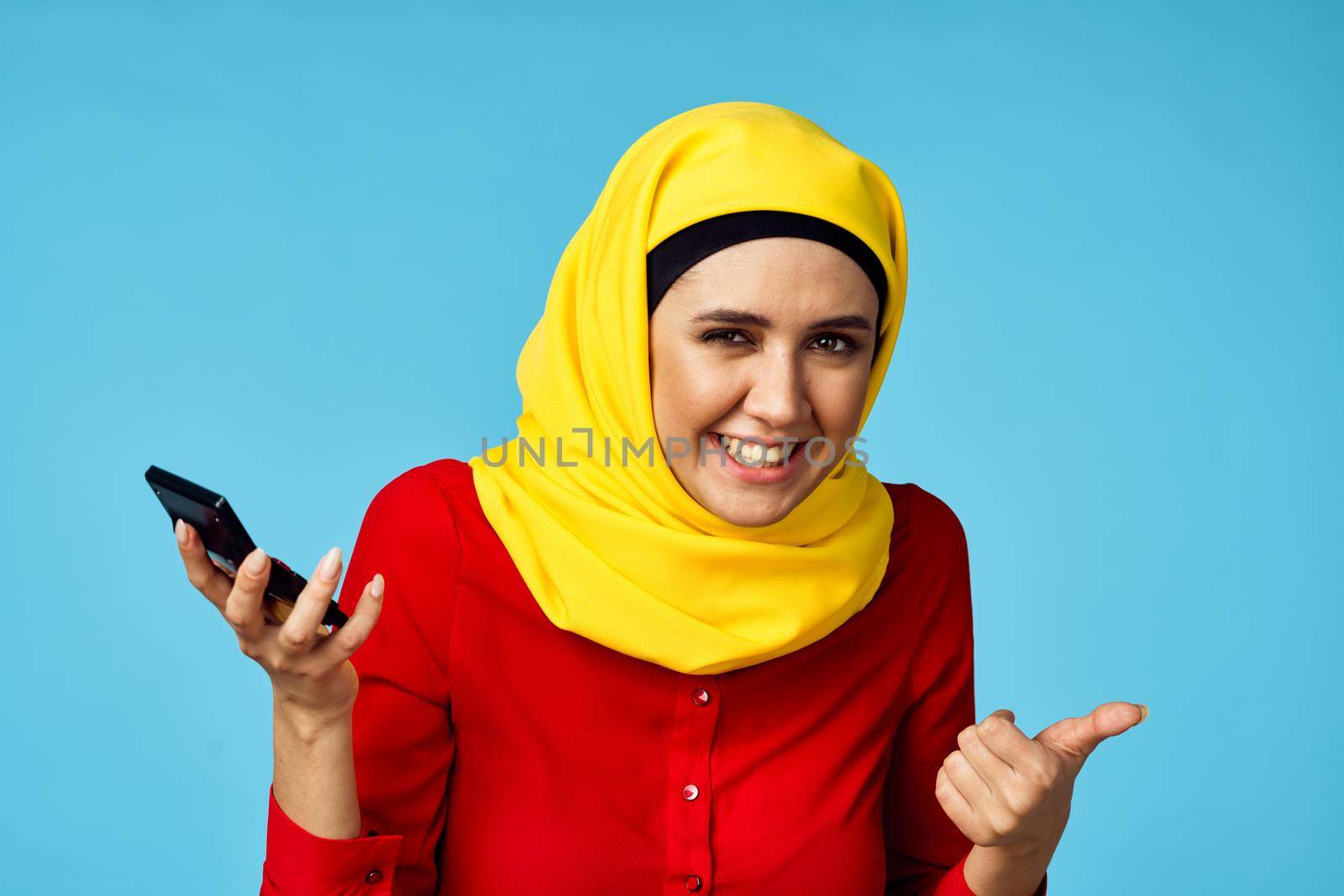 muslim woman in hijab shopping entertainment blue background. High quality photo