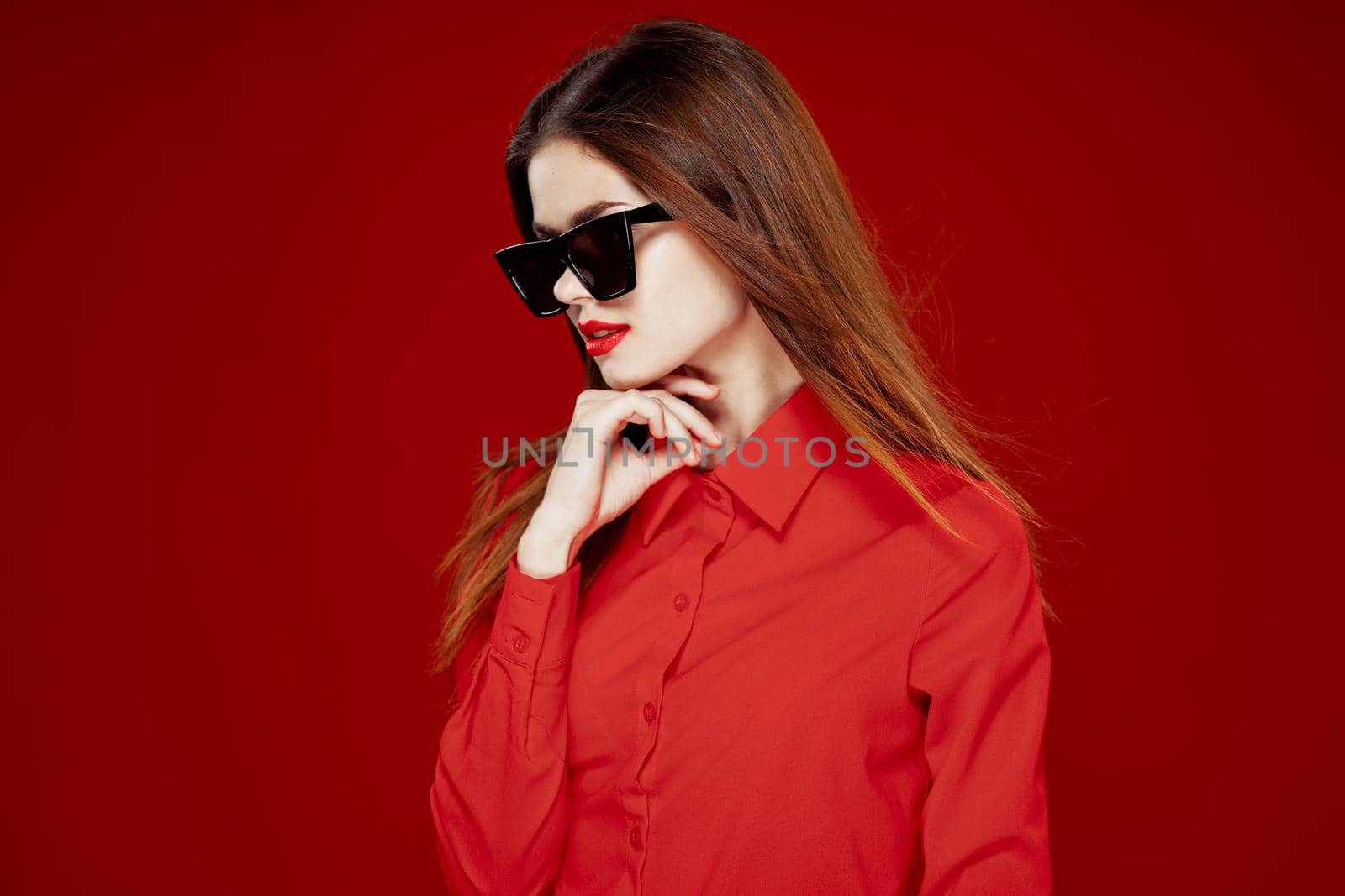 glamorous woman wearing sunglasses red shirt hairstyle model. High quality photo