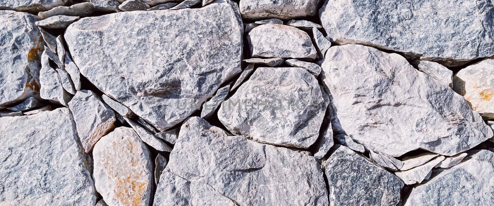 Stone texture and exterior design concept. Stonewall made of natural rocks as architectural surface background.
