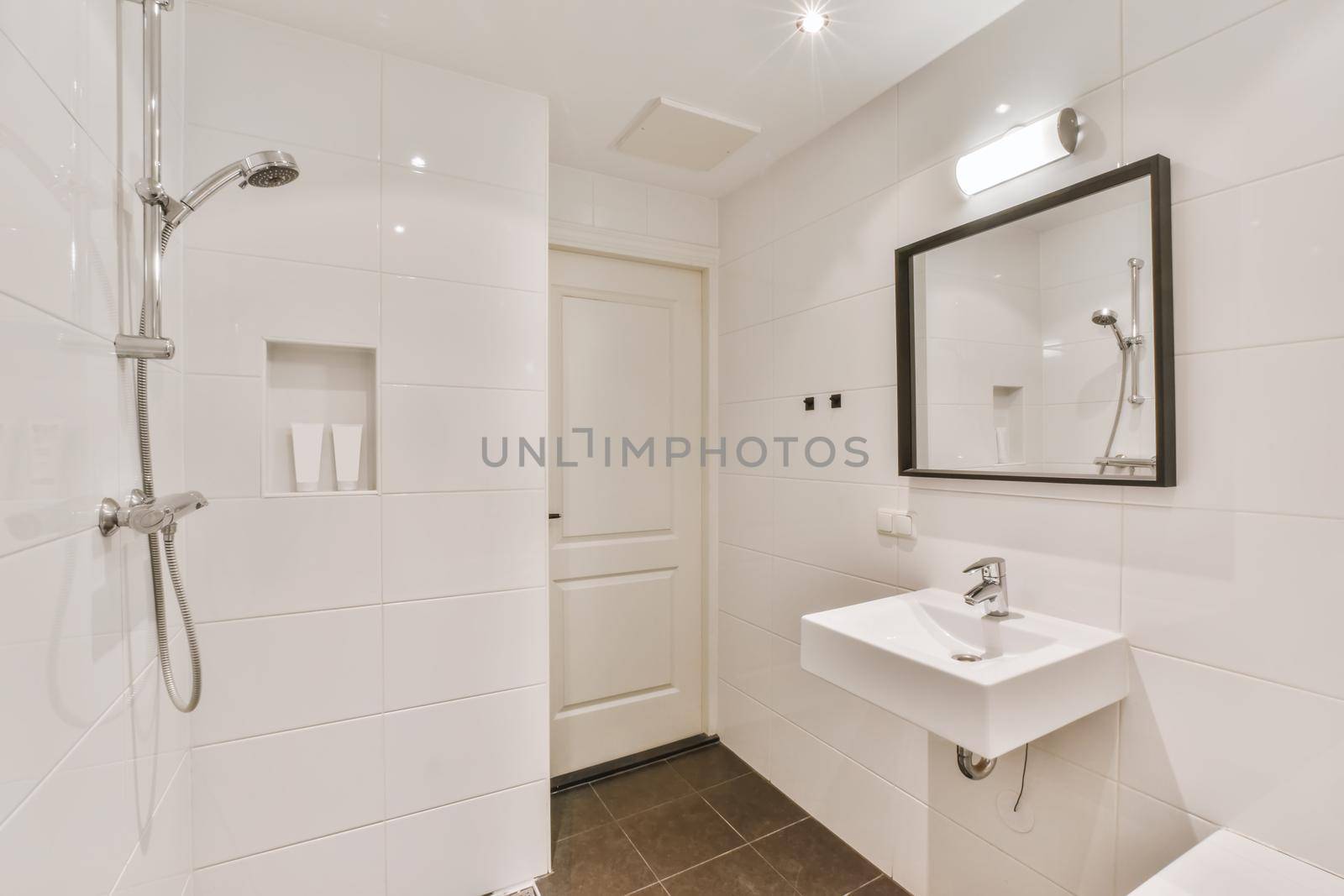 Luxurious bathroom with a large mirror in a black frame