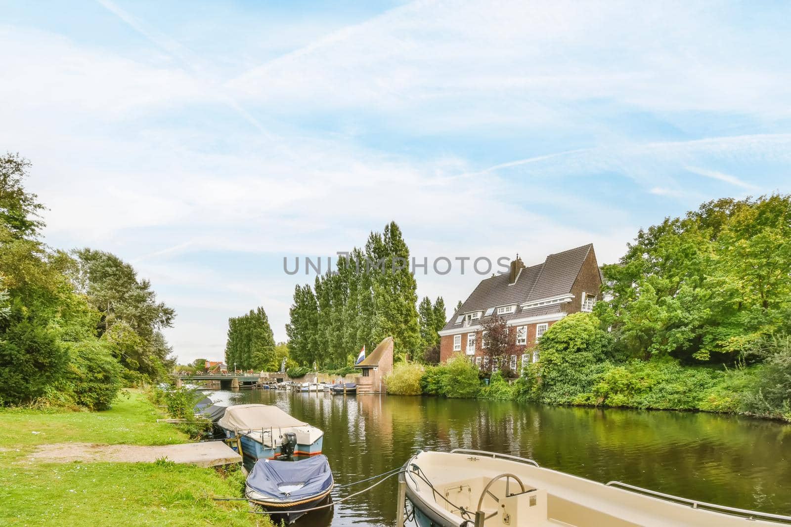 A large canal surrounded on both sides by a lawn path