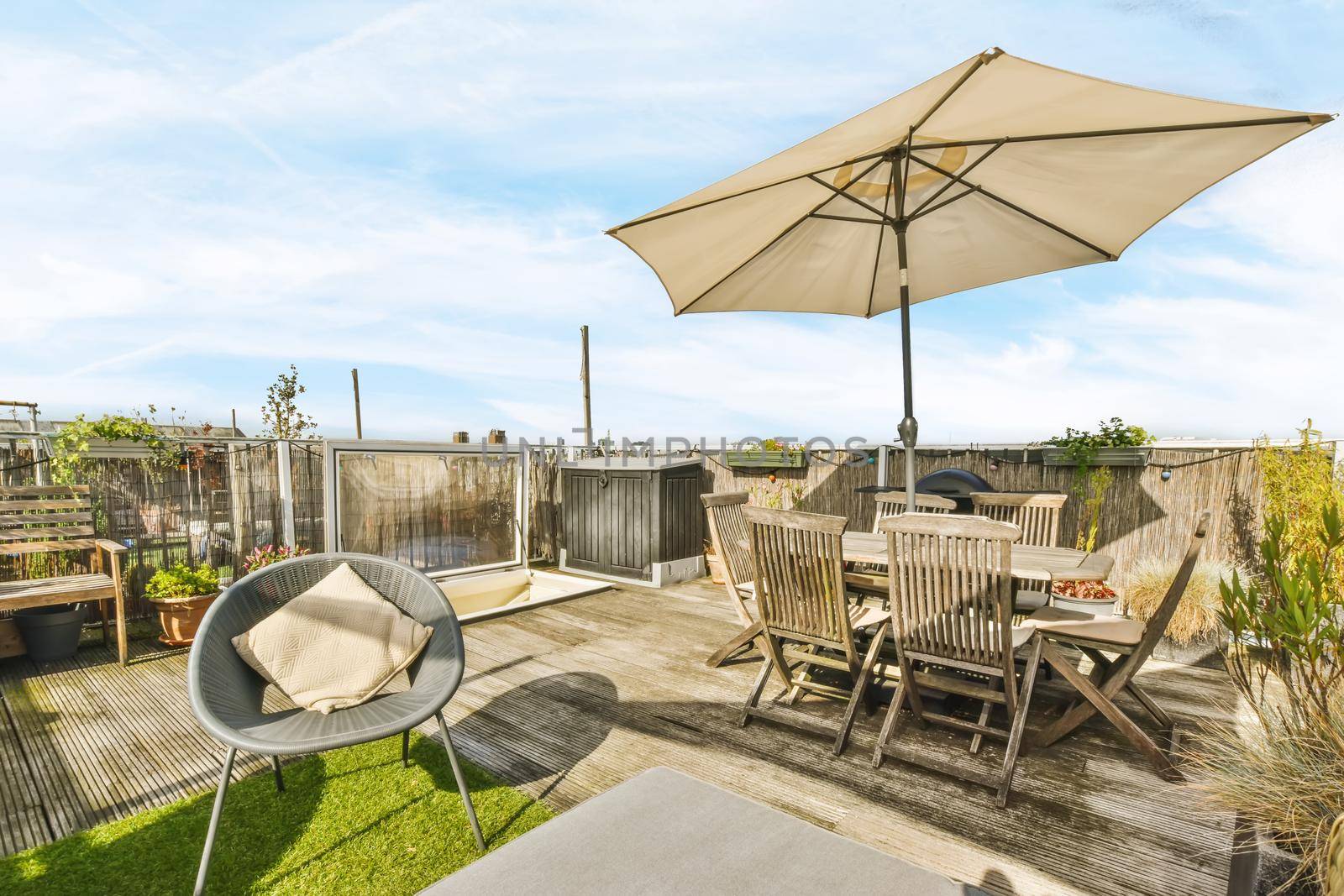Luxurious and stylish courtyard with a garden umbrella and lots of furniture