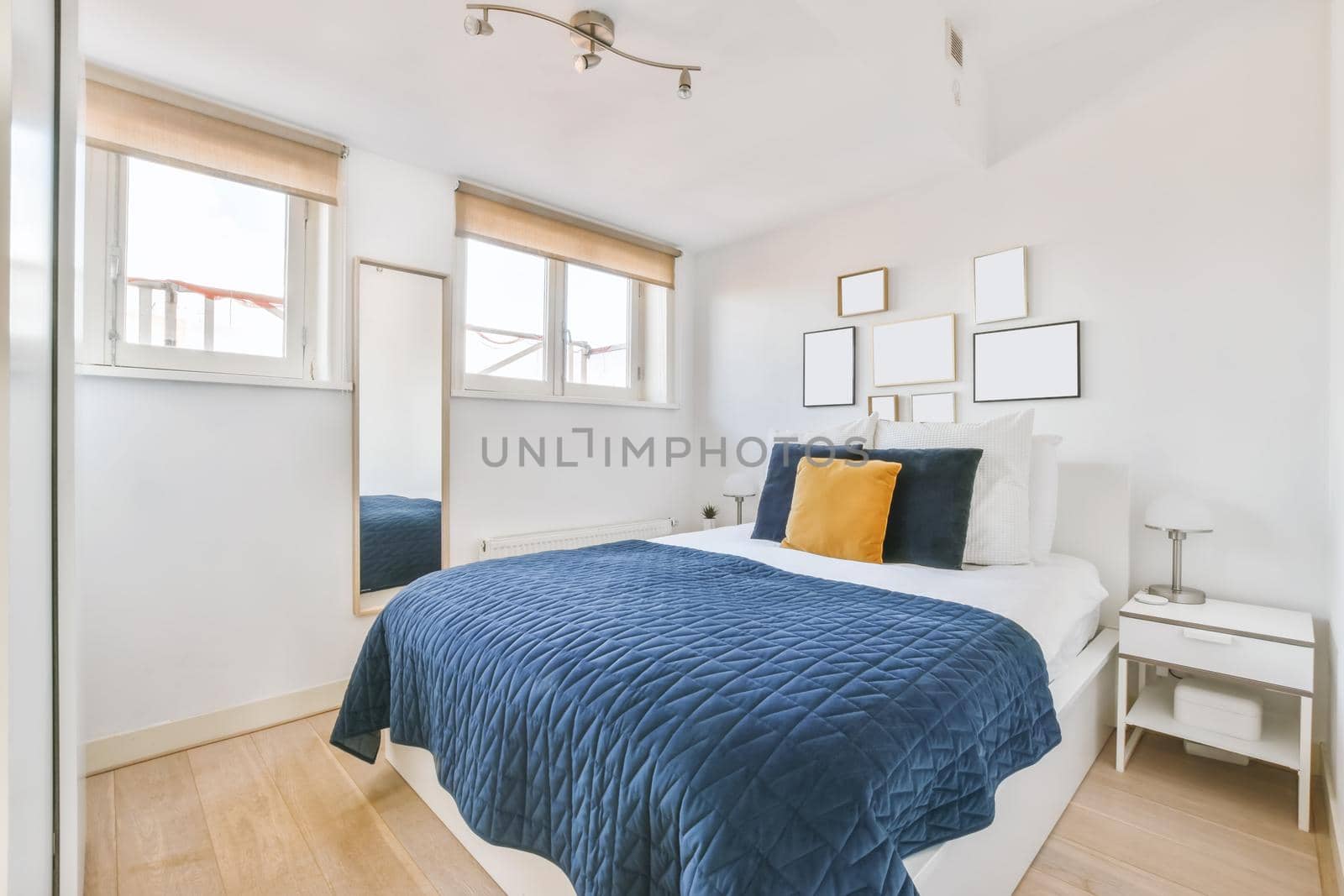 Luxurious bedroom with soft bed and blue bedspread