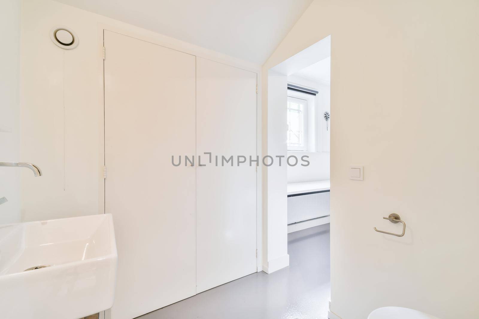 A room with an open door and a sink in an elegant home