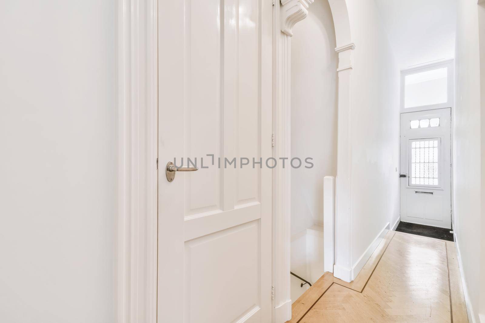 Two white doors in a bright corridor