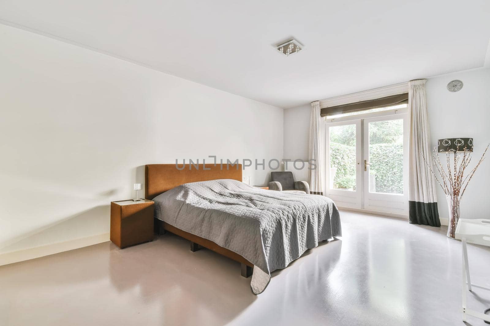 Luxurious bedroom with soft bed and fluffy bedspread