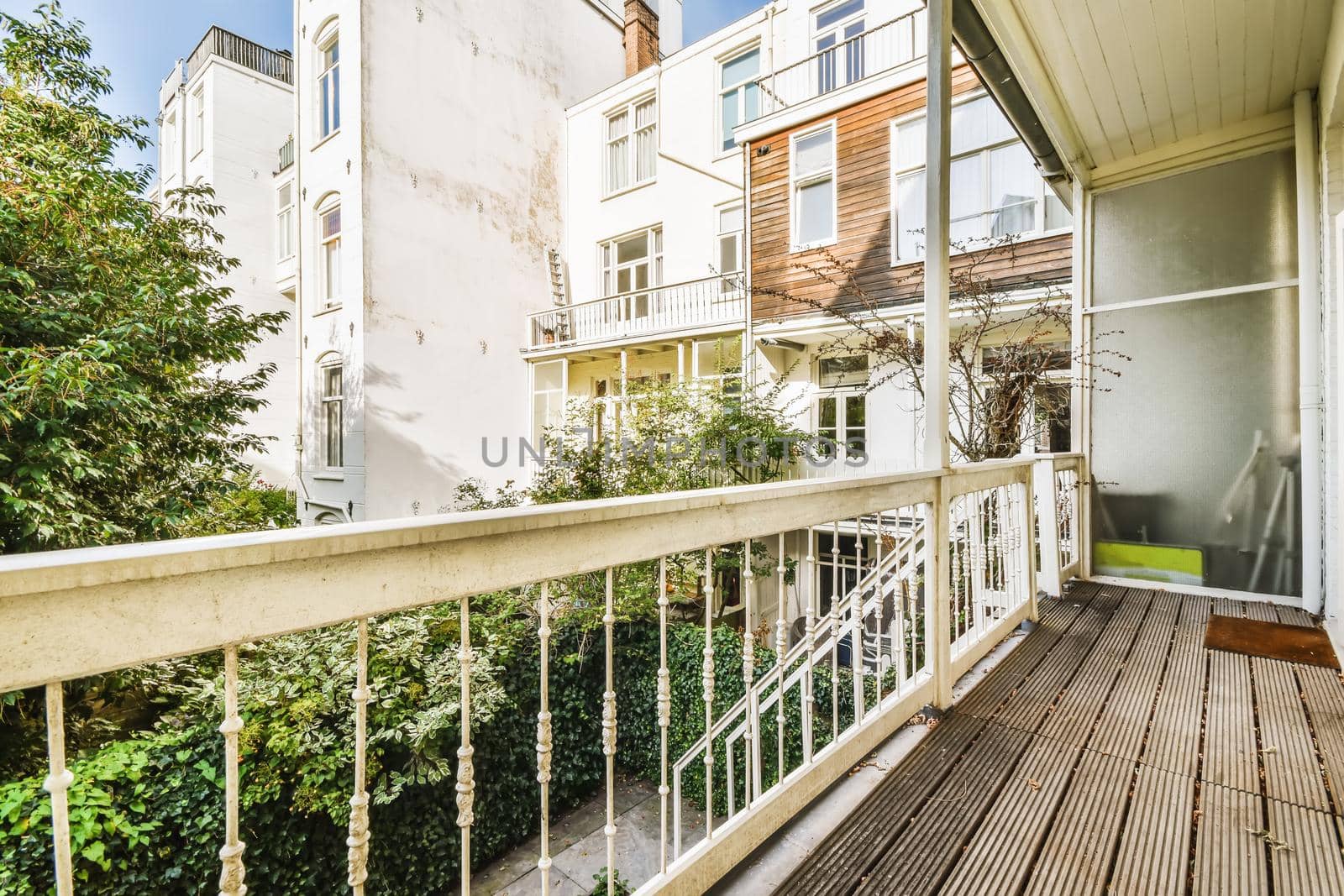 Attractive long narrow balcony with wooden handrails