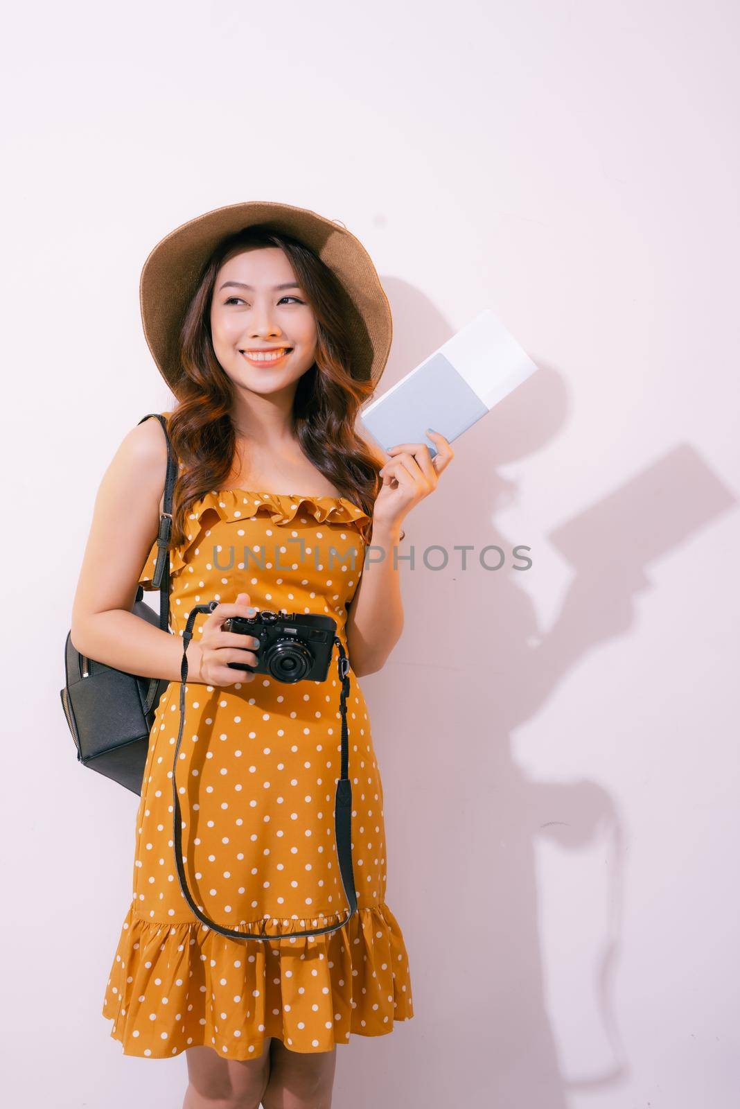 Beautiful travel woman with passport isolated on pastel backgroun