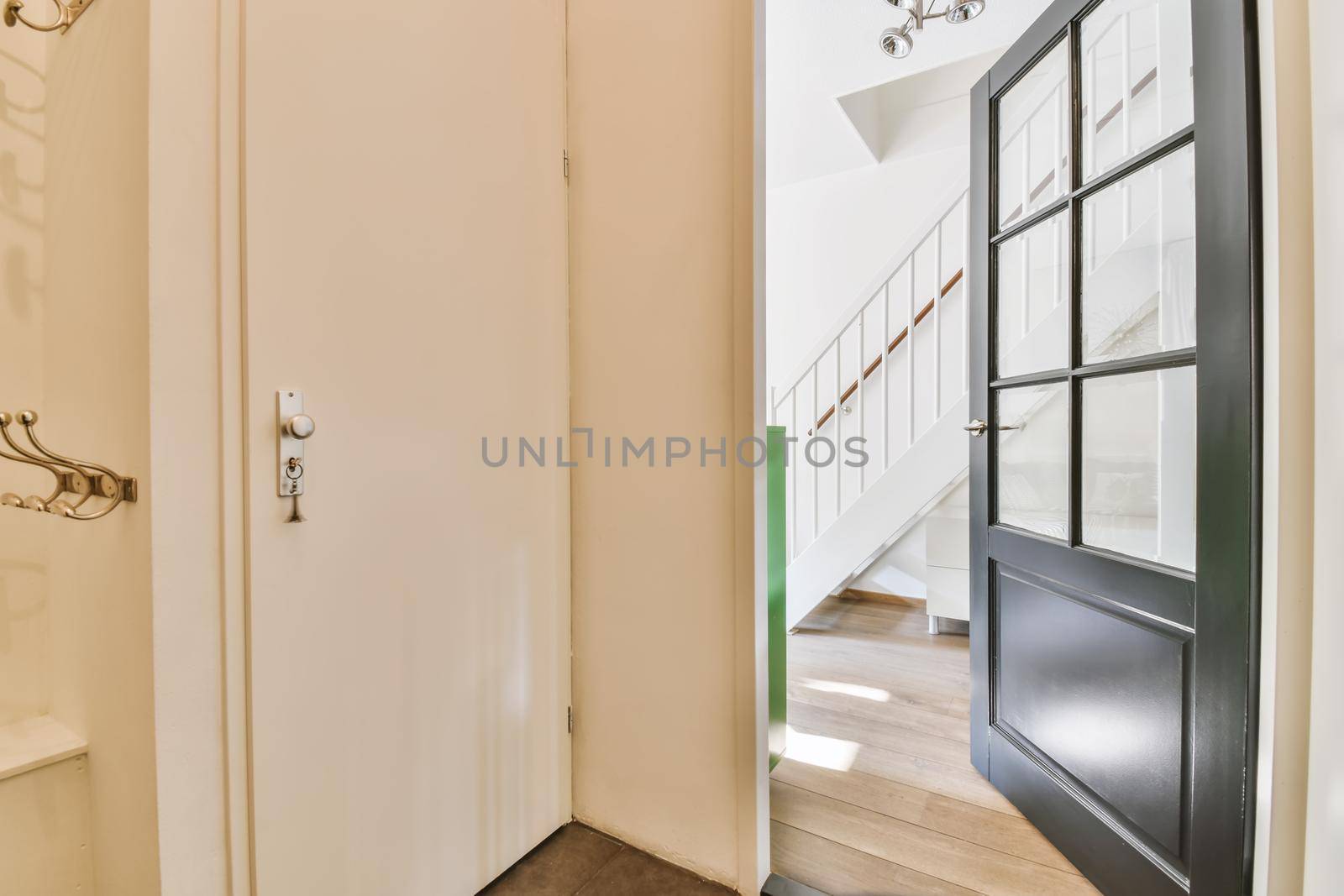 Interior of contemporary flat in minimal style with spacious hallway with white walls