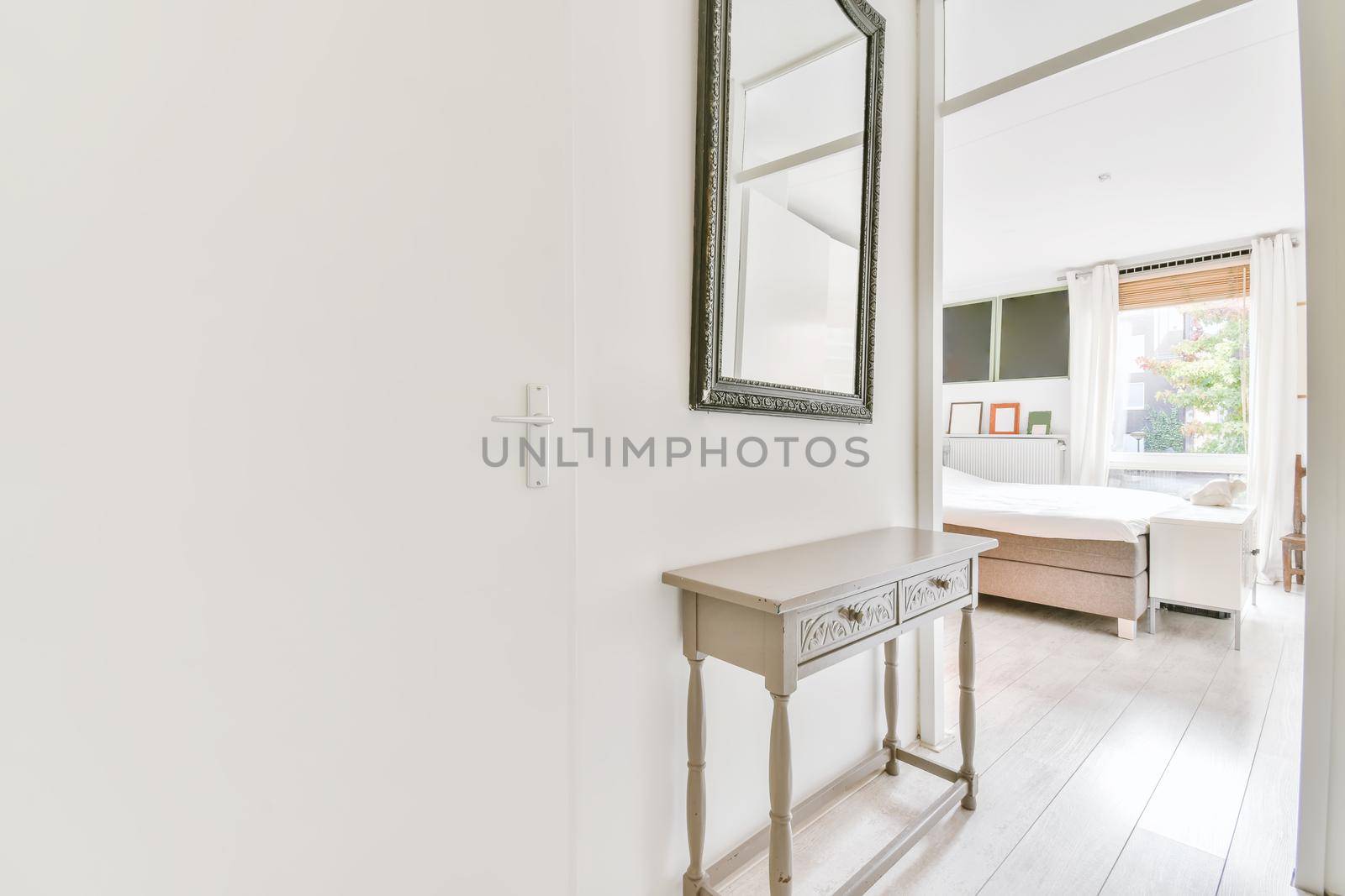 Interior of contemporary flat in minimal style with spacious hallway with white walls
