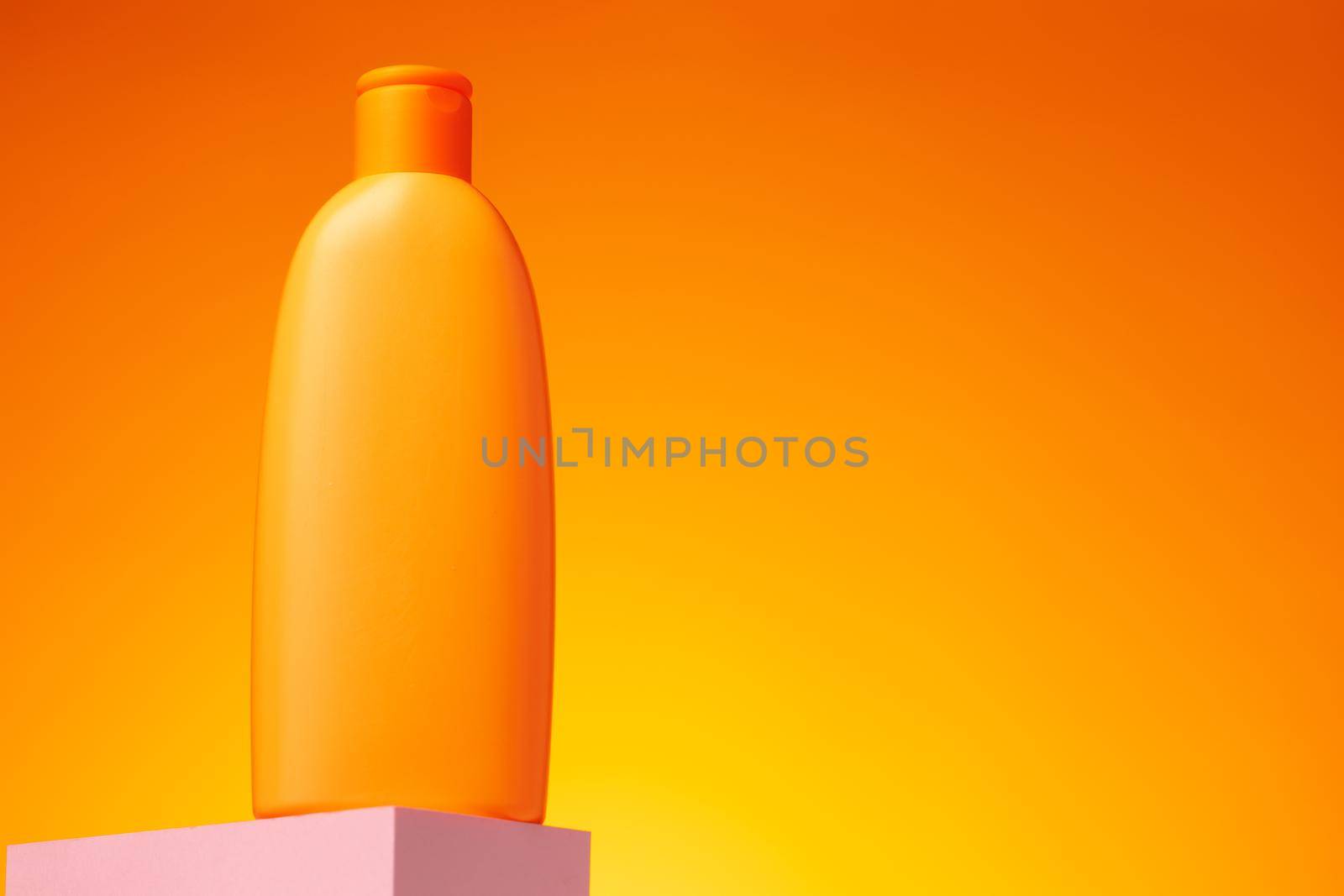 Skincare beauty products container against pink background, copy space