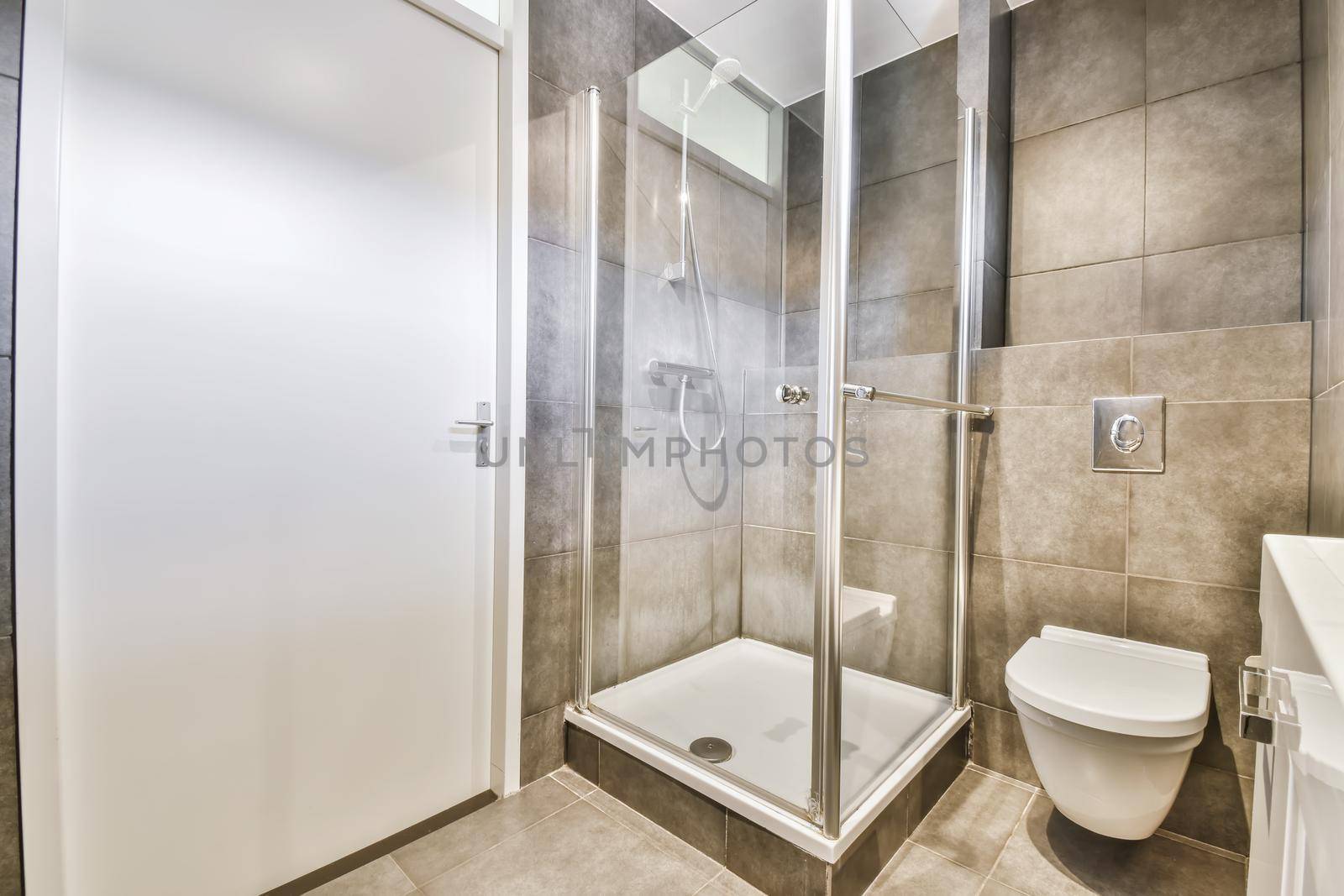 Modern home interior design of white bathroom with open shower separated from toilet