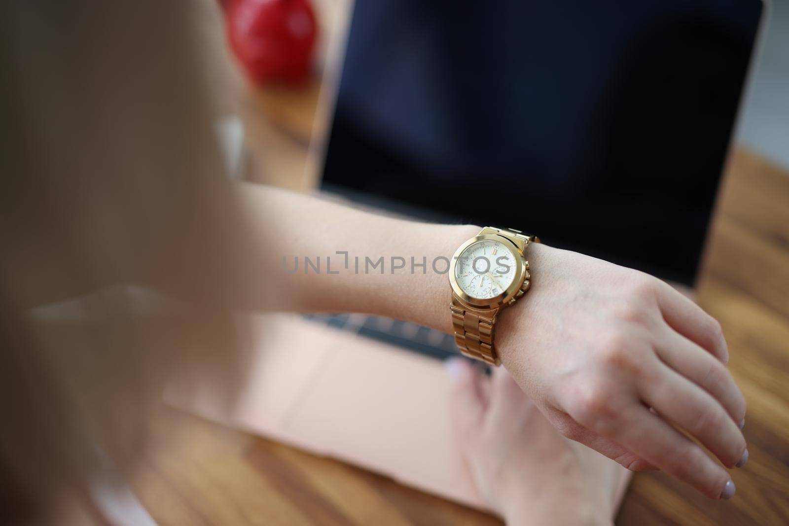 Office worker woman look at time on wristwatch and wait end of shift by kuprevich