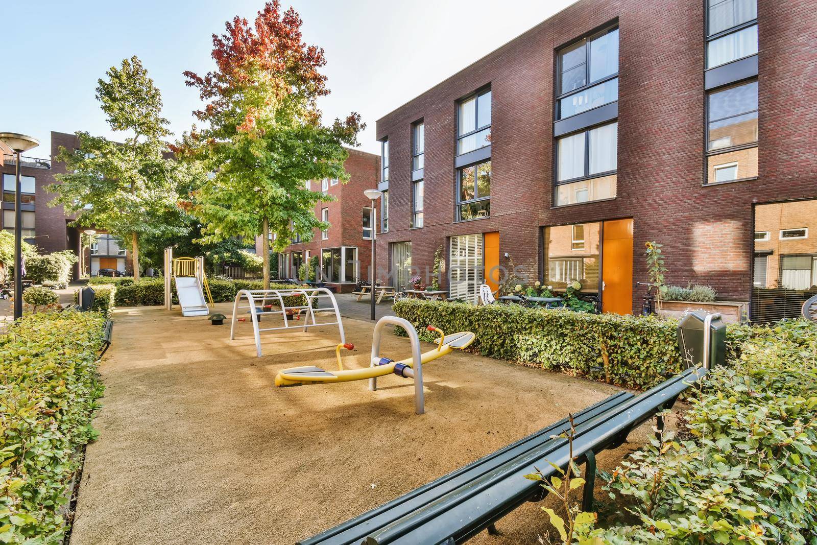 The courtyard of the house with a playground with a swing