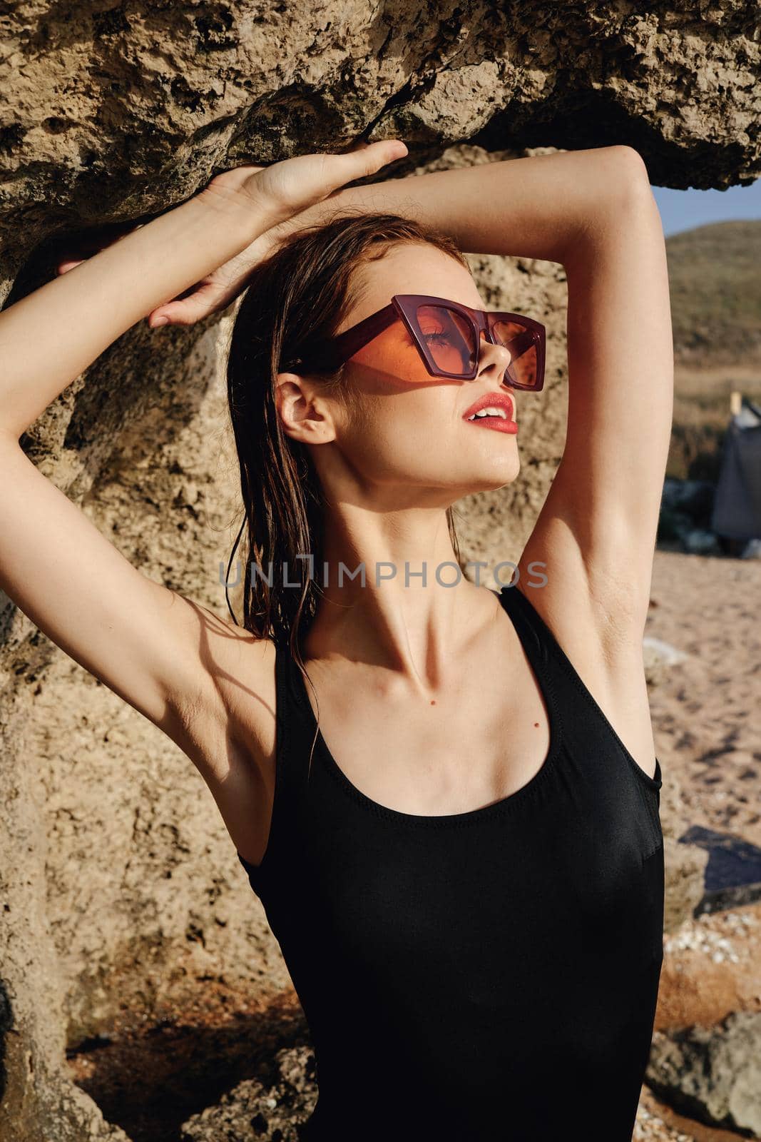 pretty woman in black swimsuit sunglasses posing sun. High quality photo