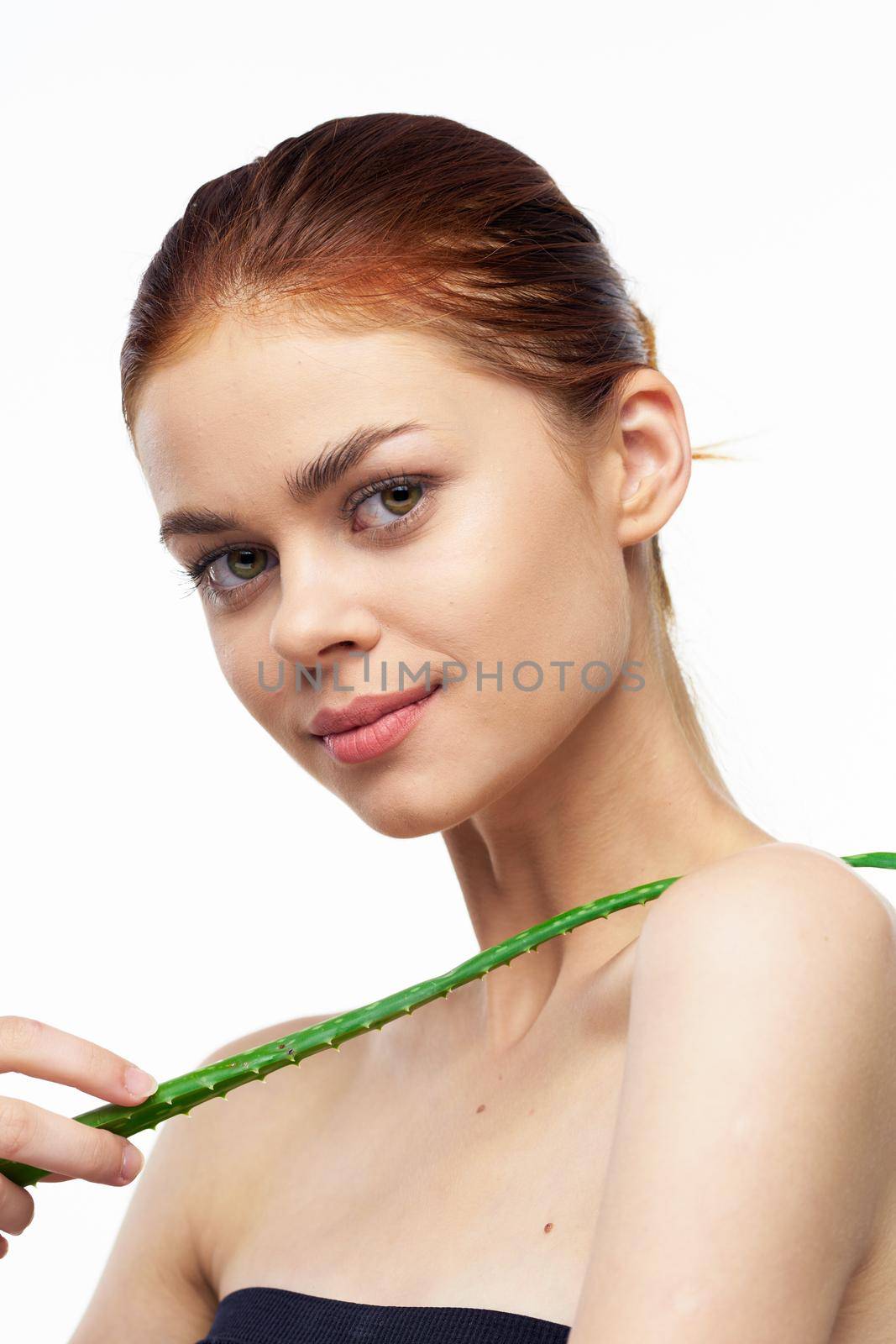 woman with bare shoulders aloe cosmetics spa treatments. High quality photo