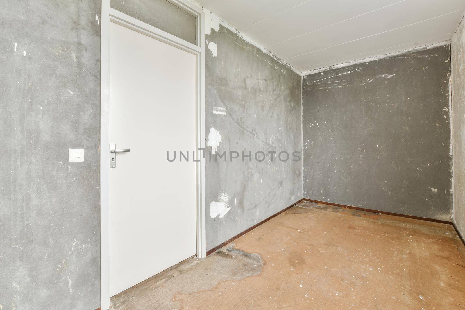 Modern room with wooden floor and white walls