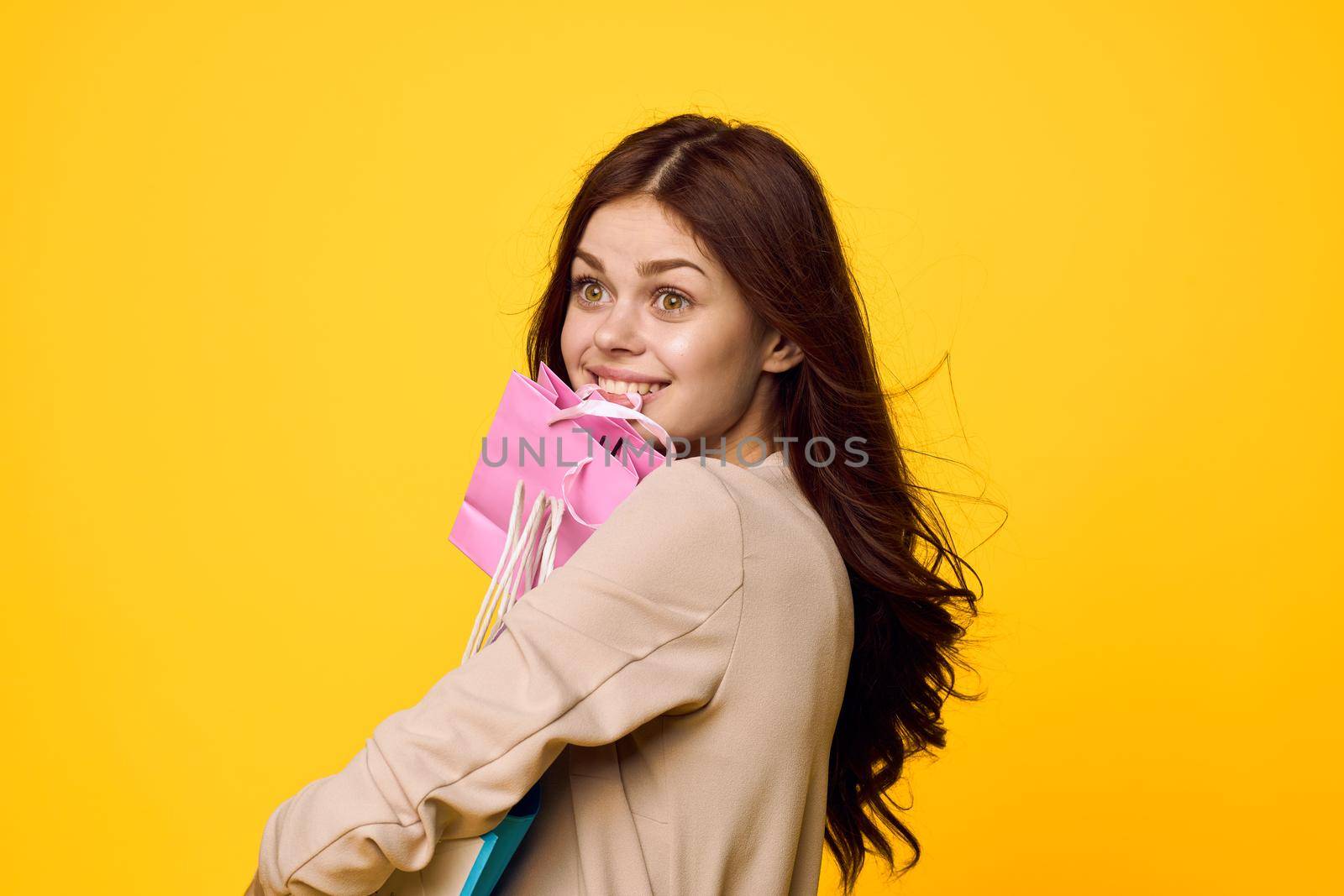 glamorous woman shopping entertainment lifestyle yellow background. High quality photo