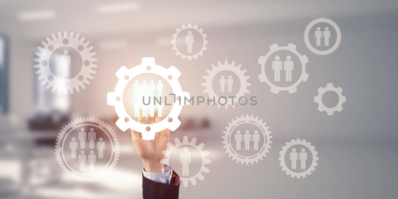 Close of businesswoman hand touching gears on screen with finger and office at background