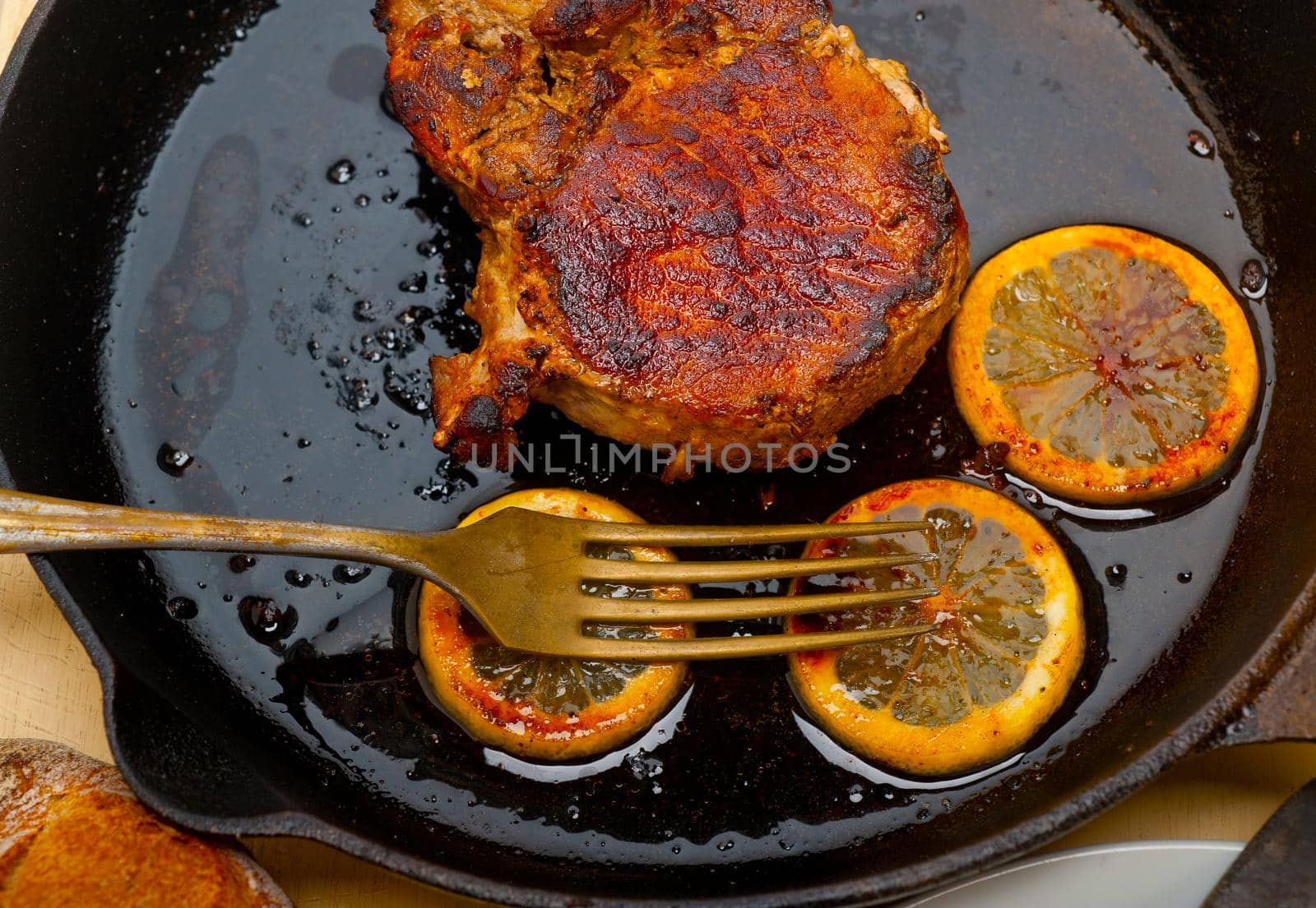 pork chop seared on iron skillet by keko64