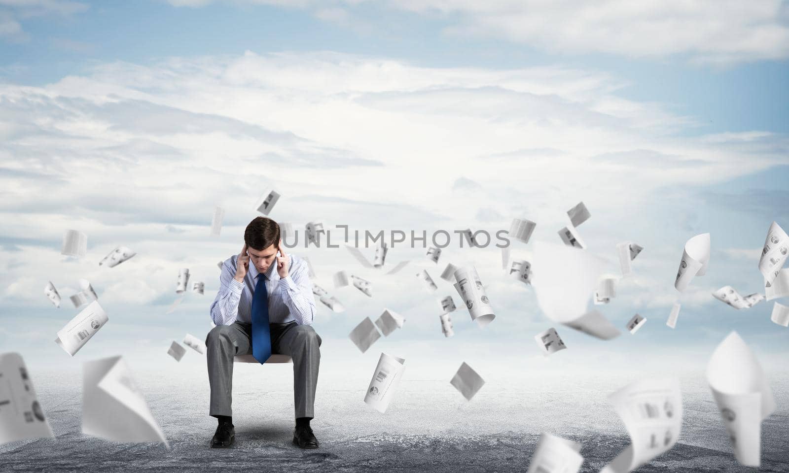 Businessman is sitting on an office chair with his head in his hands. Business stress and problems