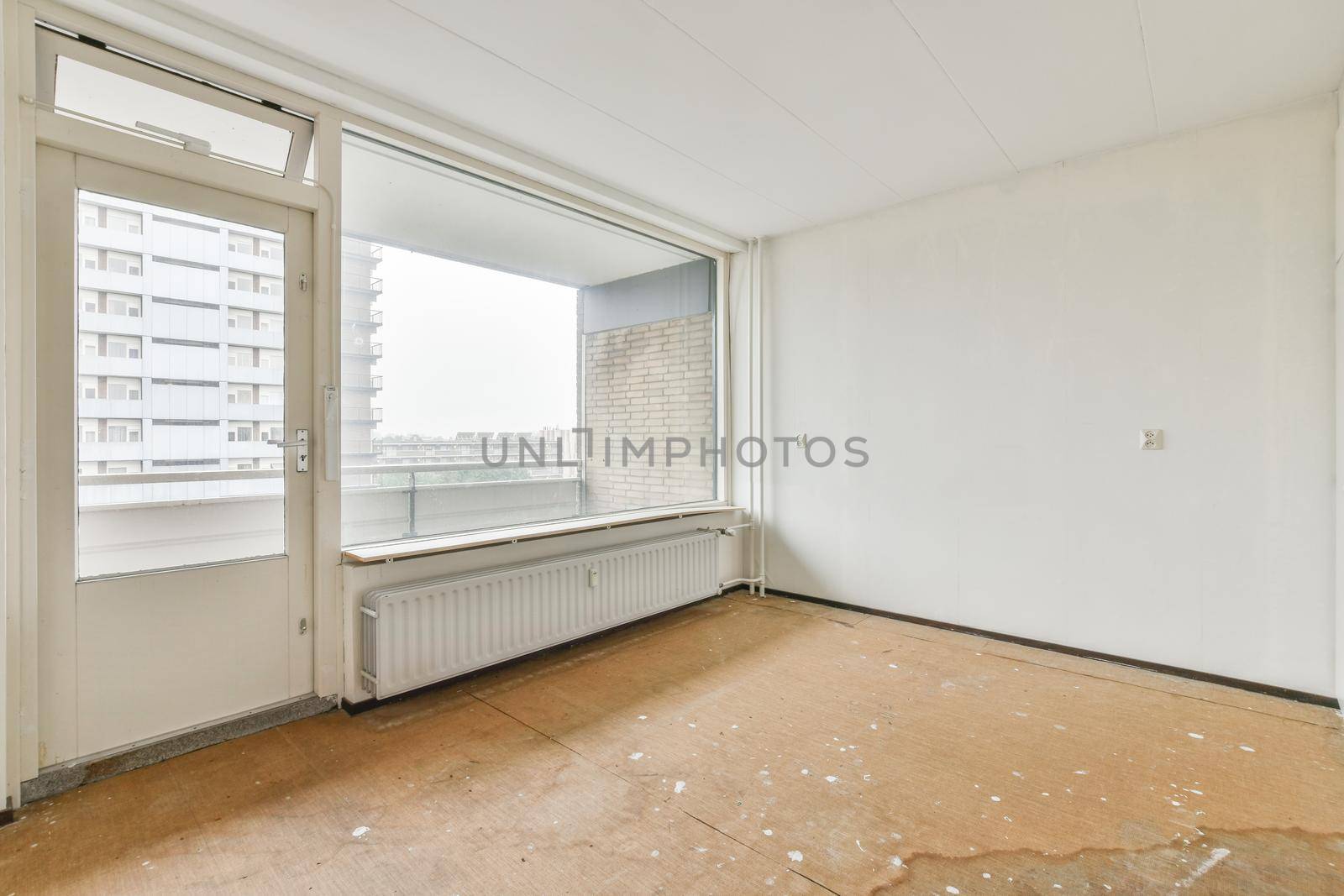 Modern room with wooden floor and white walls