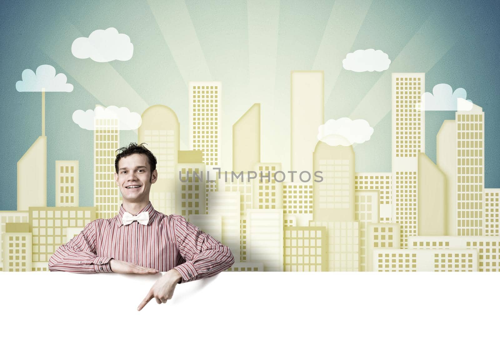Young funny guy in checked shirt pointing with finger at blank banner